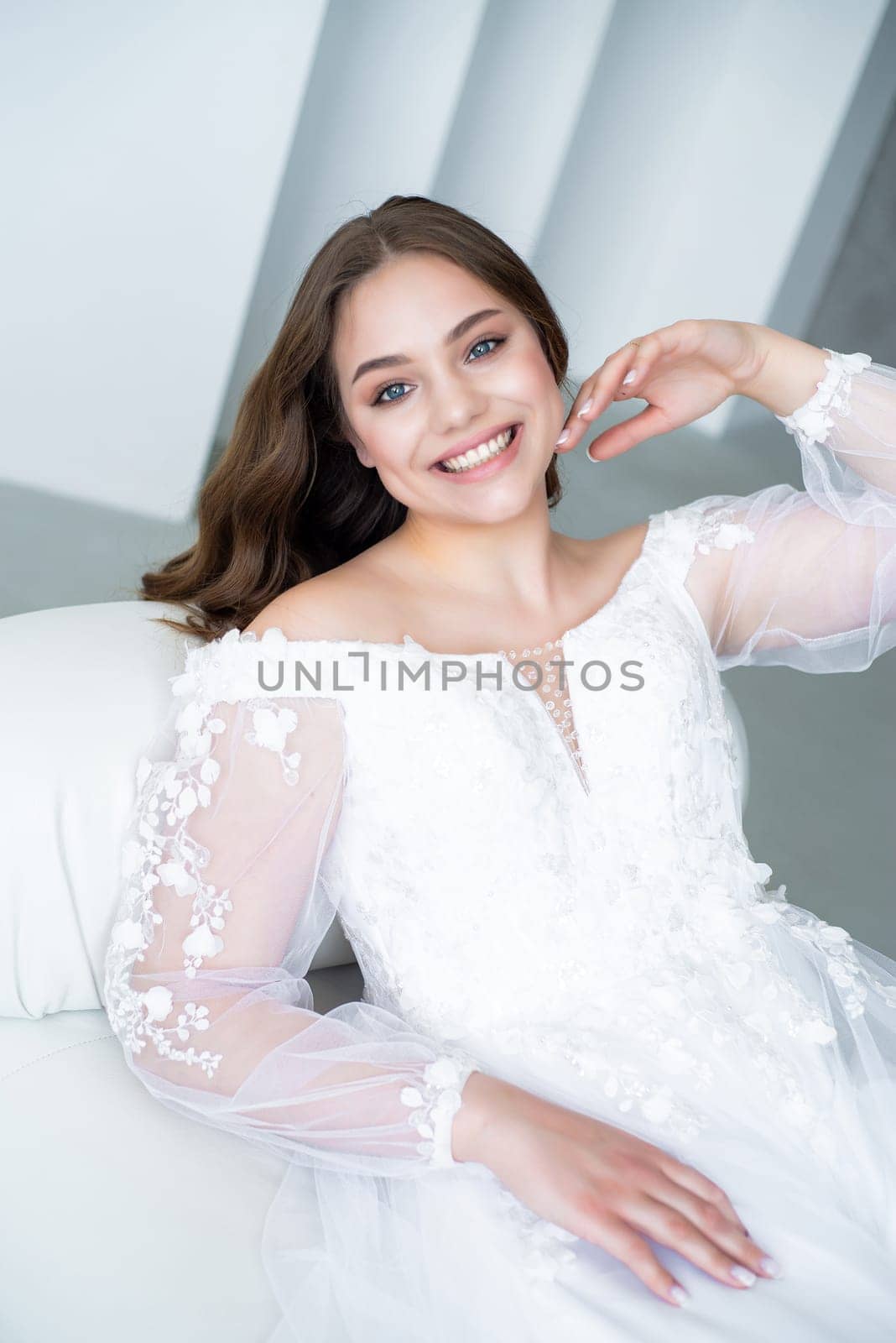 portrait of beautiful young woman in white wedding dress posing in studio