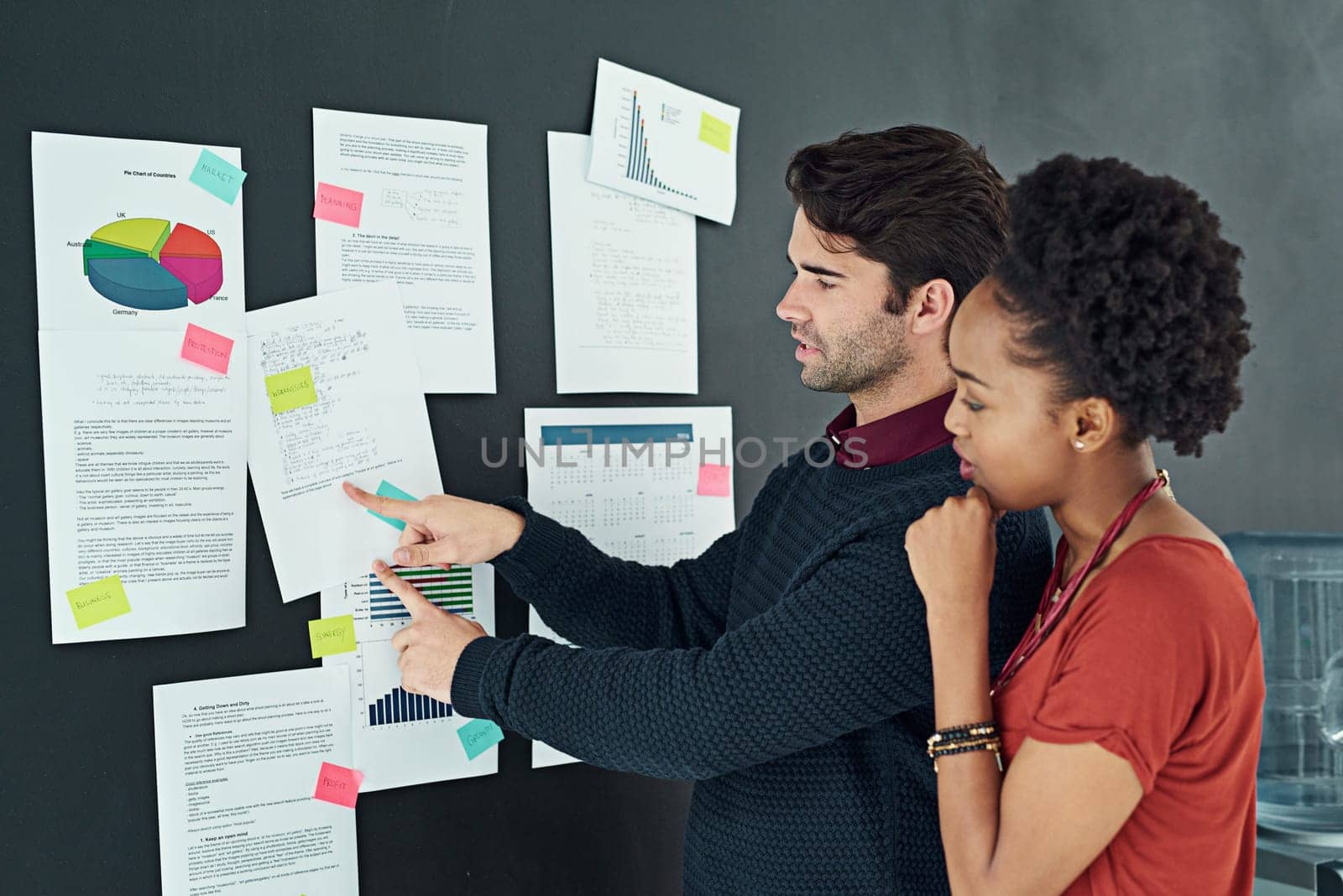 Business people, meeting and strategy with documents on storyboard, sticky note and project timeline with teamwork. Corporate collaboration, discussion and paperwork for research, analysis and graphs by YuriArcurs