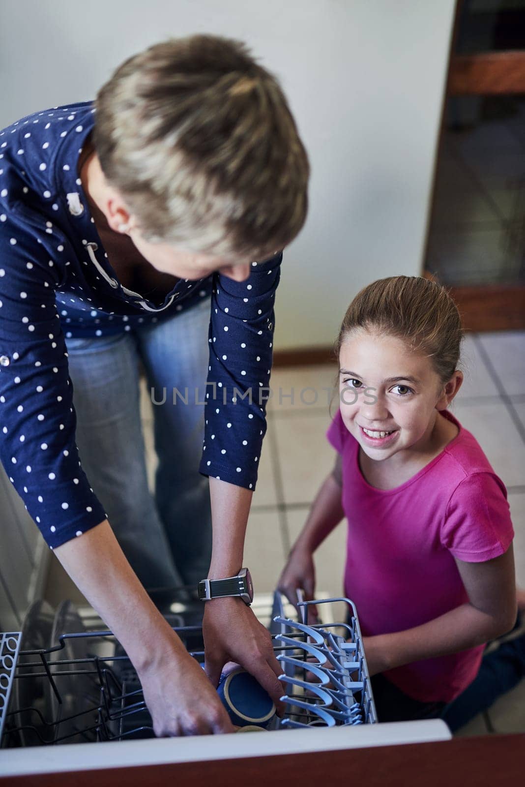 Dishwasher, mother and daughter in portrait cleaning kitchen together with help, learning or teaching. Housework, mom and girl in home washing dishes in machine with smile, support and morning chores.