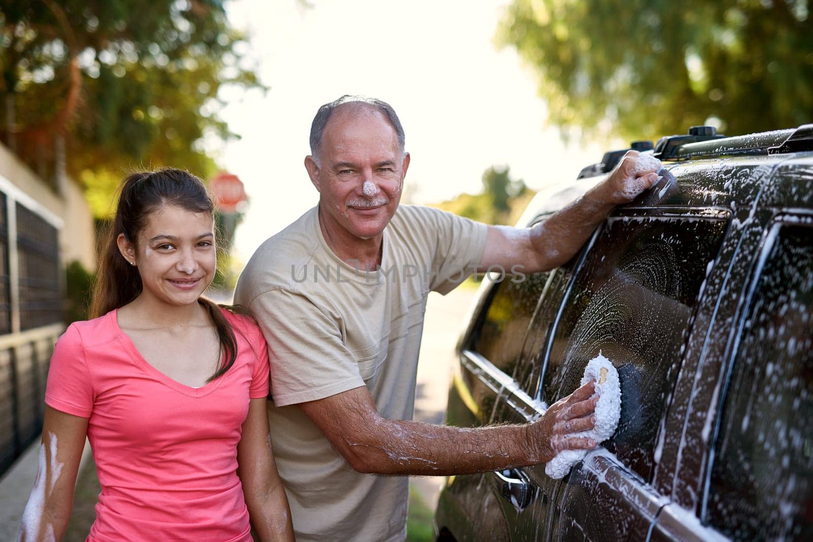 Family, washing car and portrait of man with daughter outdoor for cleaning in summer. Kids, love or smile with father and girl child in driveway to polish vehicle for responsibility or transportation.