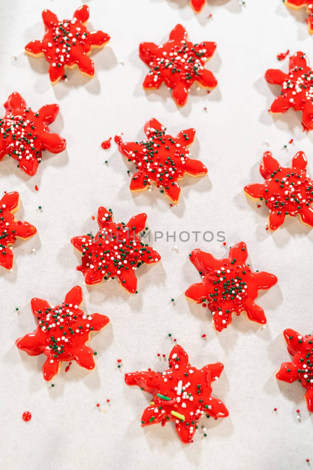 Red Iced Star Cookies with Green Sprinkles, Holiday Baking by arinahabich