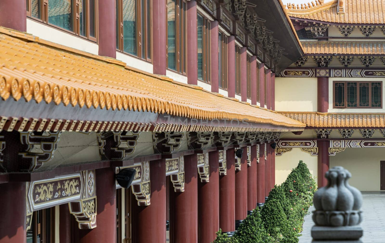 Bangkok, Thailand - Apr 11, 2024 - Perspective exterior view of Gable roof and slab of colored tiles at Fo Guang Shan Thaihua Temple. The Institute of Buddhism, Taiwanese temple style, Space for text, Selective focus.