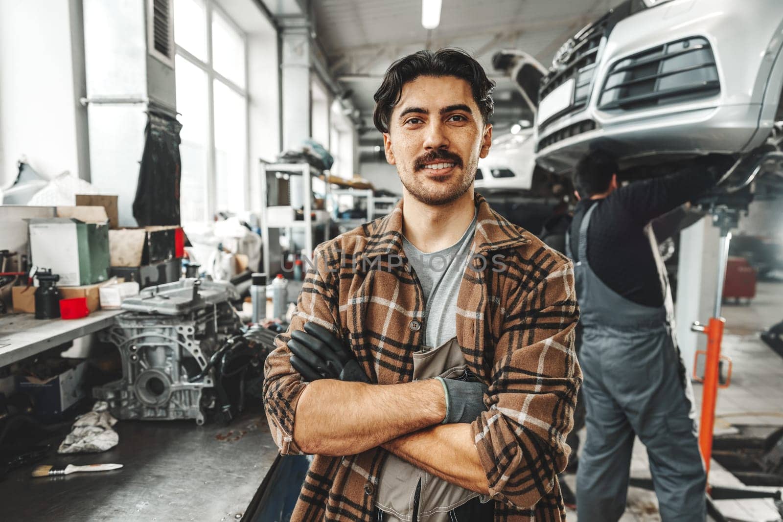 Portrait of a male mechanic in an auto repair shop close up