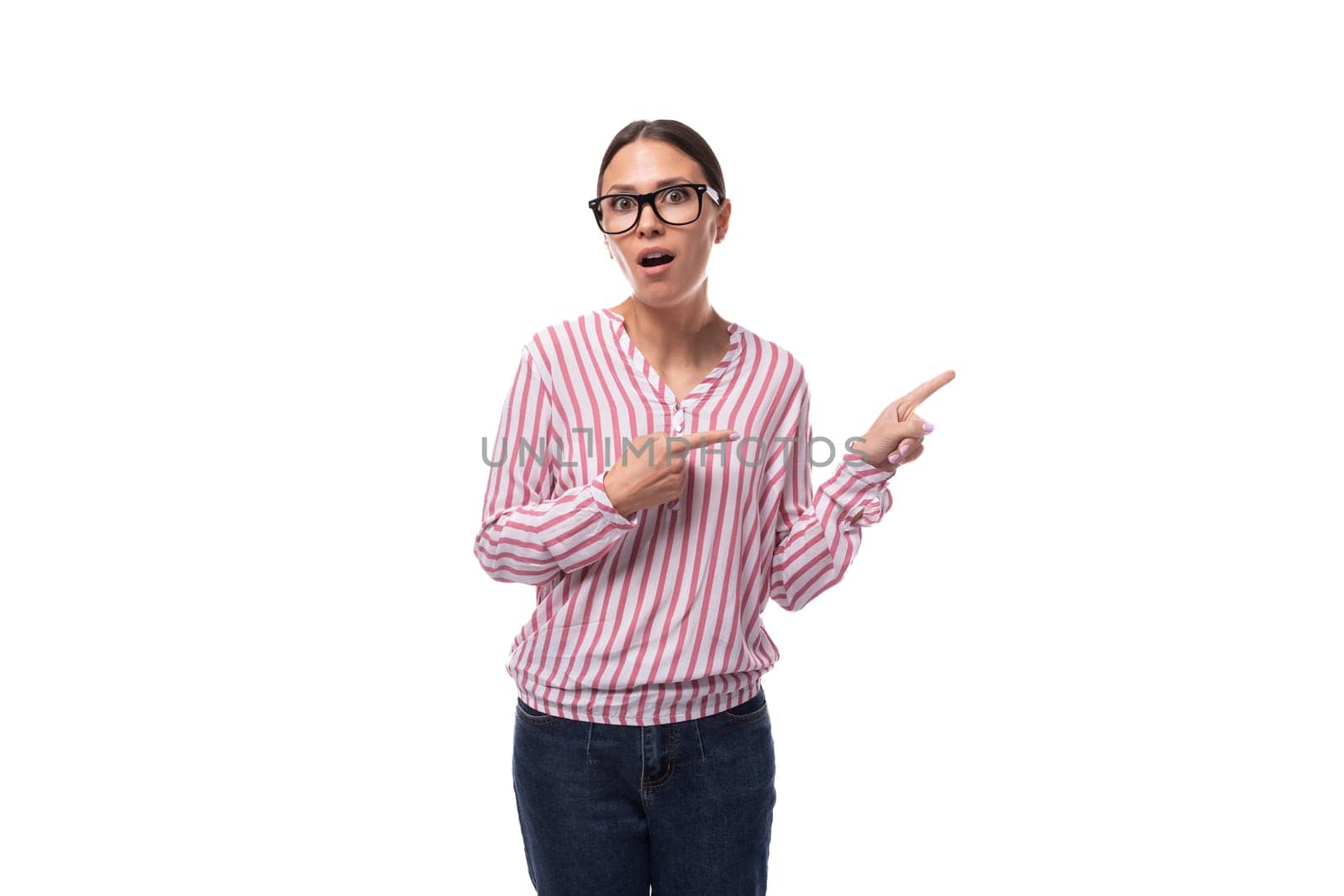 young joyful office worker woman dressed in a pink-white shirt points to an empty space by TRMK