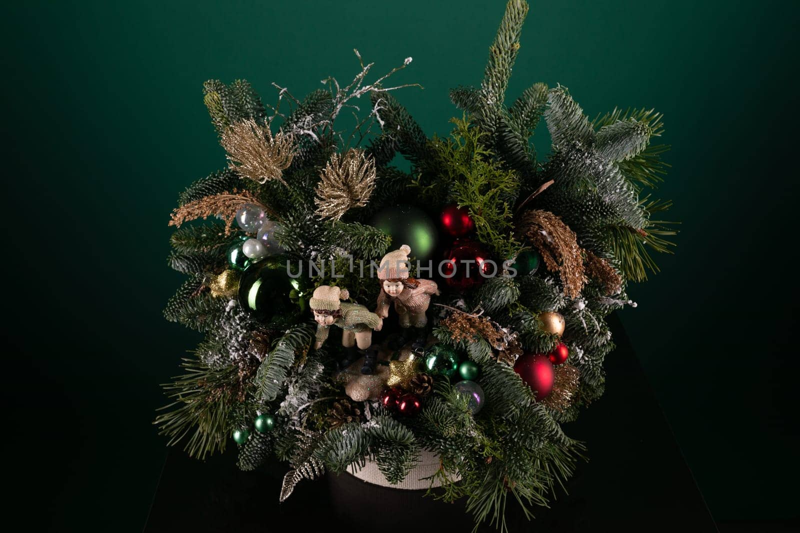 A potted plant is decorated with festive Christmas ornaments and lights, adding a touch of holiday cheer to the indoor space. The decorations include colorful baubles, twinkling lights, and a sparkling star on top.