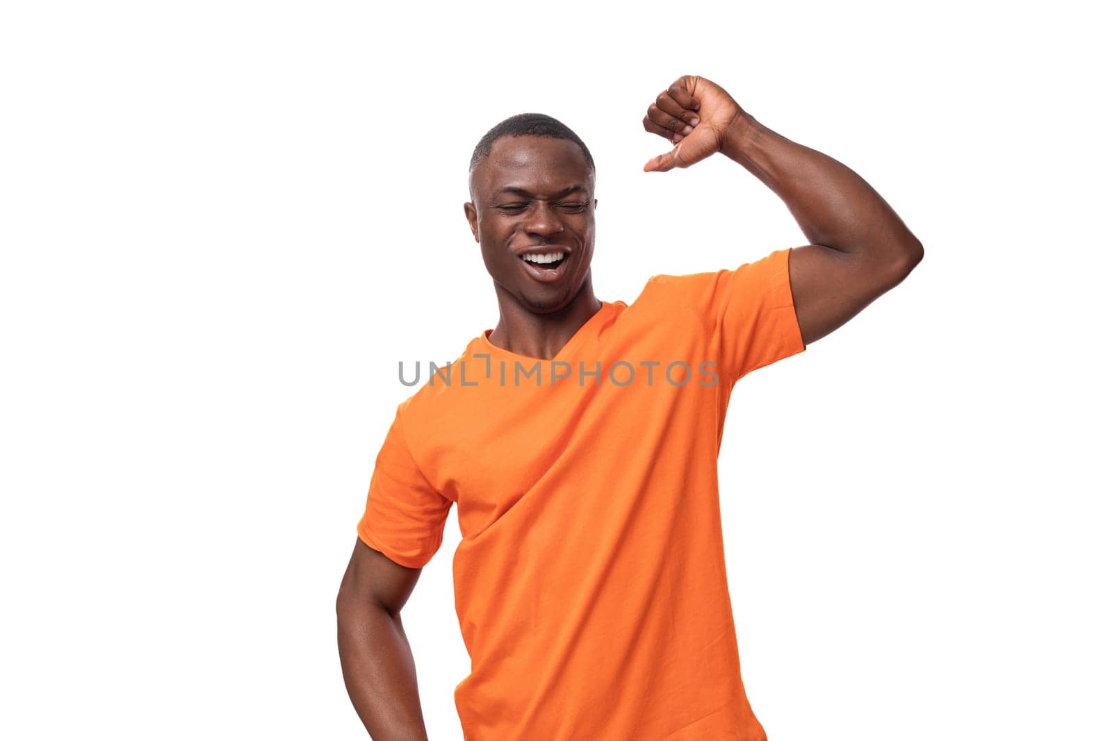young slender American man dressed in an orange cotton t-shirt with a mockup. corporate color concept.