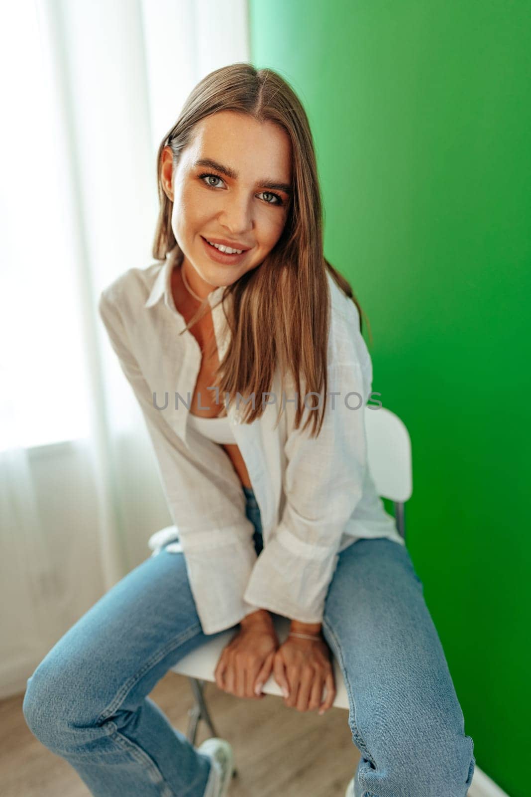 Portrait of attractive lovely girl wearing crop top and shirt posing over green studio background by Fabrikasimf