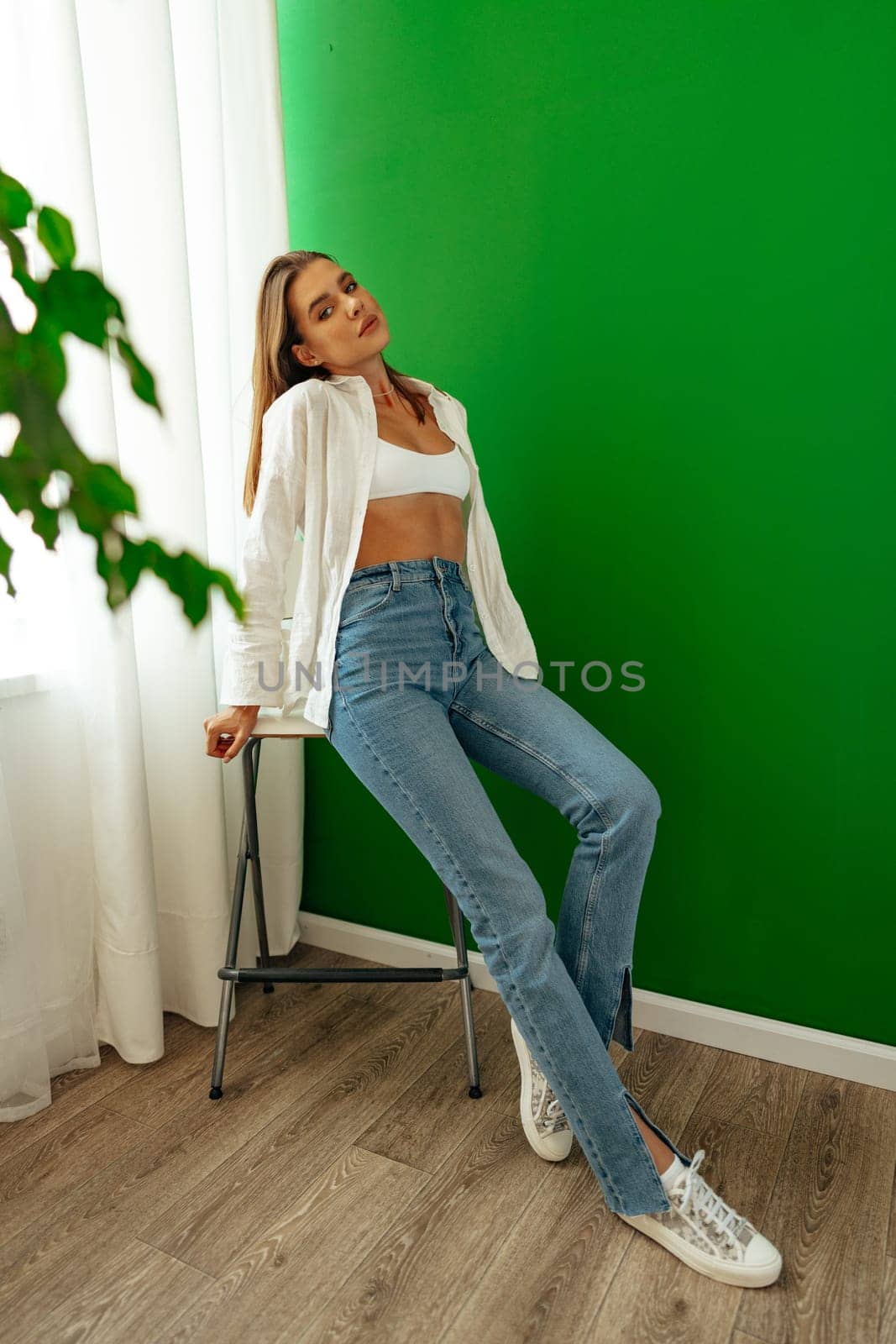 Portrait of attractive lovely girl wearing crop top and shirt posing over green studio background by Fabrikasimf