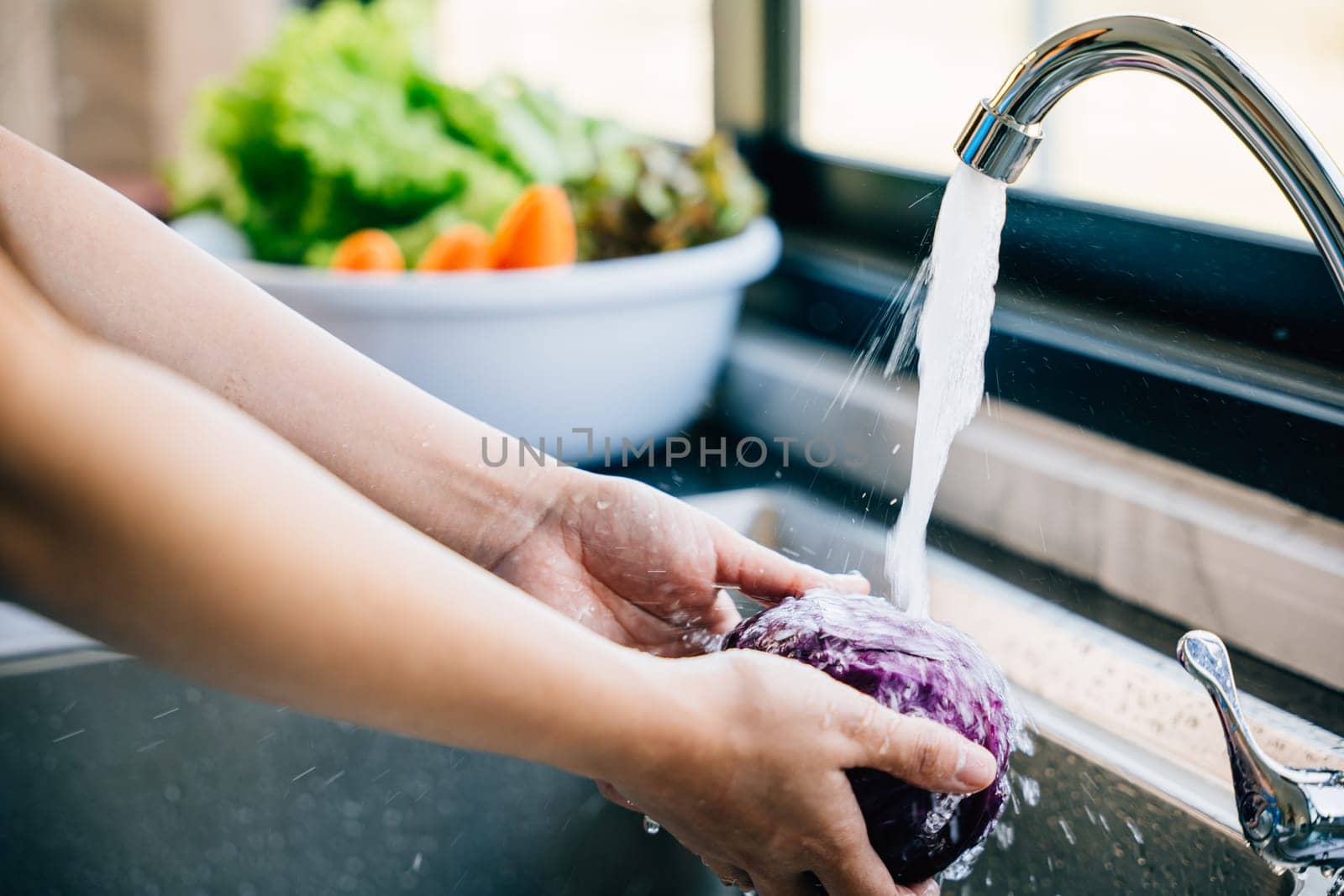 Bright clean vegetables being washed by Sorapop