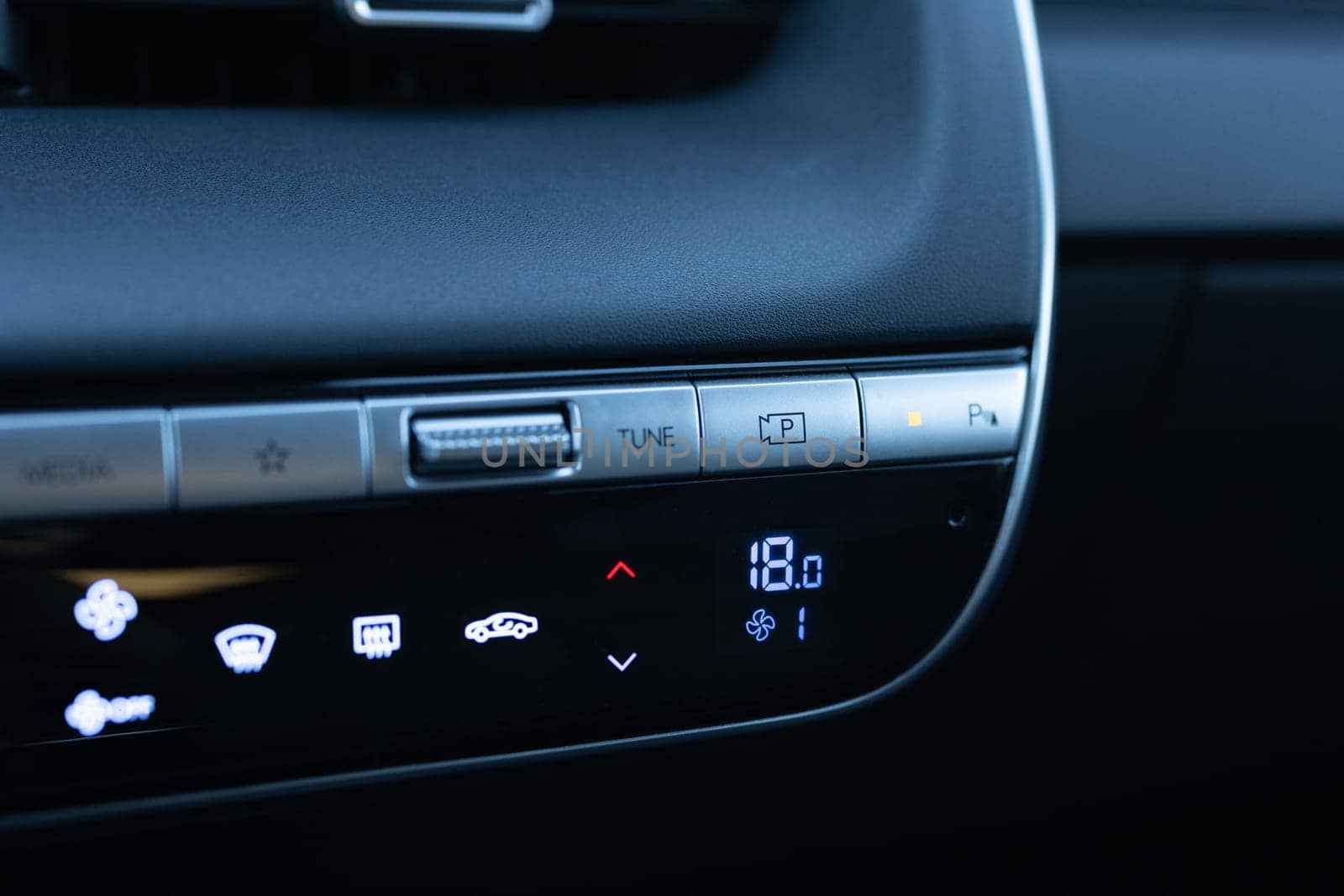 360 degree camera buttons in a new luxury electric vehicle. Electric car control devices. Modern car climate control panel for driver and passenger with shallow depth of field.