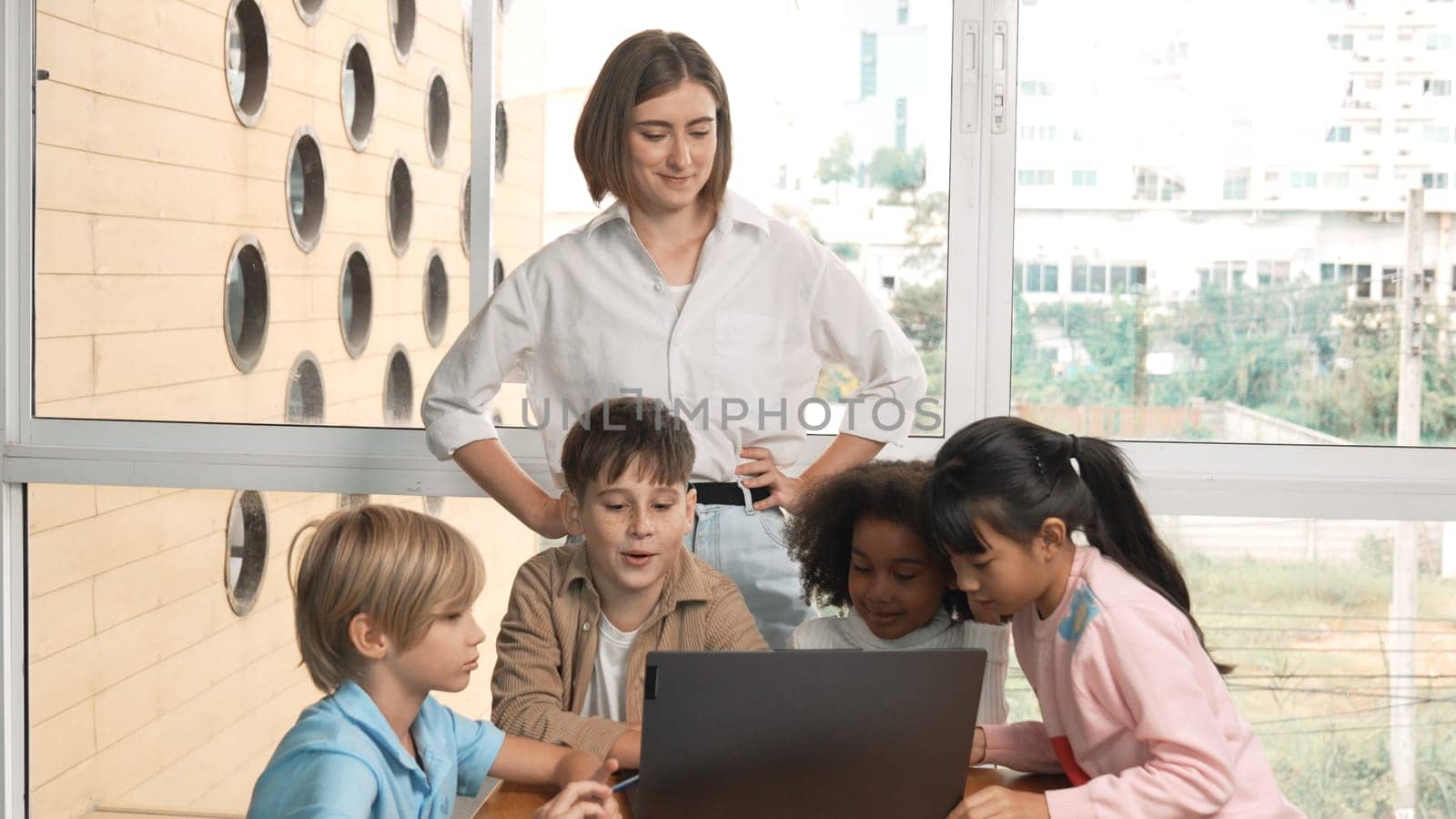 Cute african girl programing system while surround with caucasian teacher and diverse friend. Professional instructor explain and teaching coding engineering prompt while student listening. Erudition.