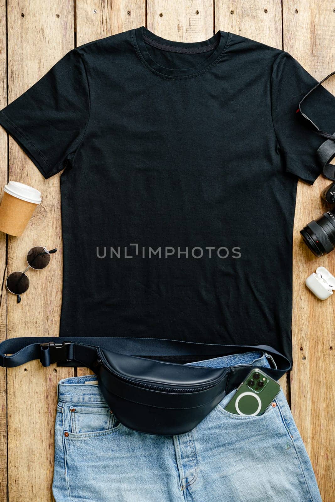 T-shirt with jeans shorts placed on the wooden background top view