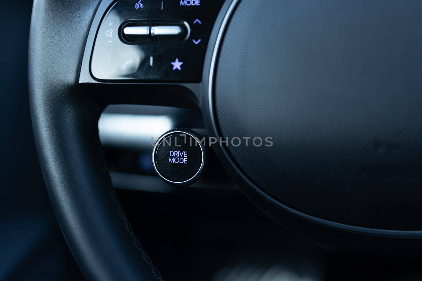 Drive mode button on luxury electric car dashboard. Relaxed and fuel efficient driving mode. Energy-saving button DRIVIE MODE is working while driving, energy-saving driving mode by uflypro