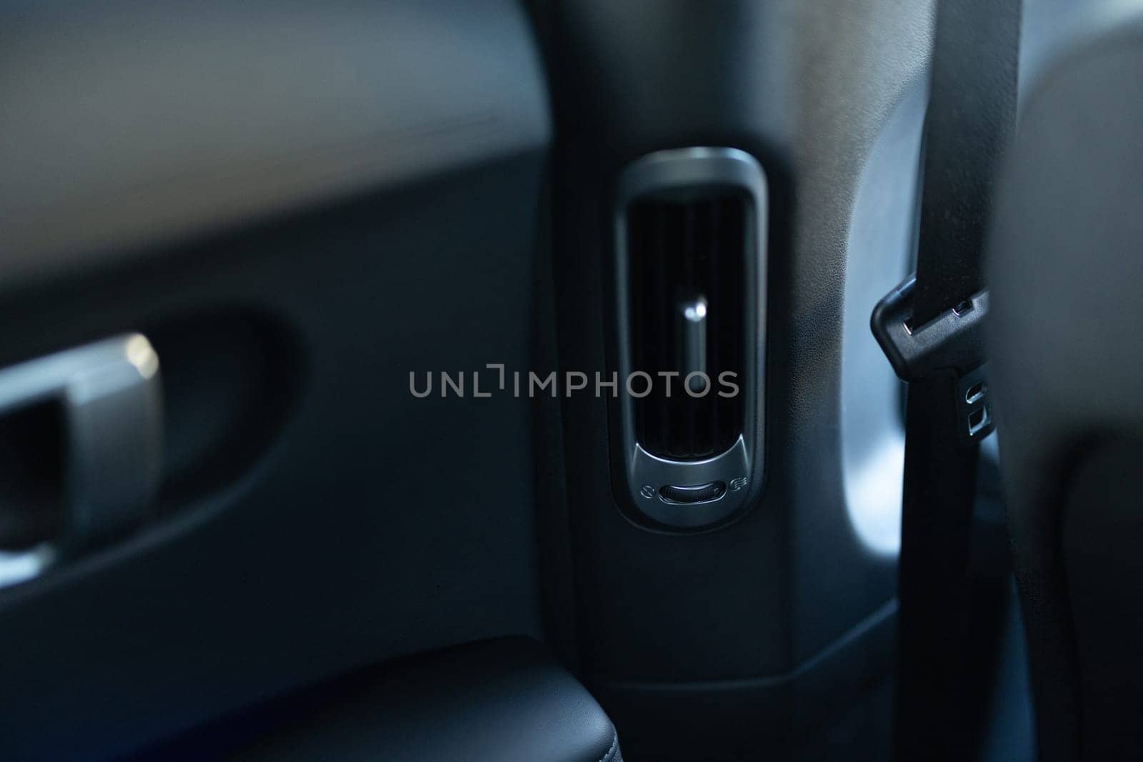 Interior details of a modern car Close-up view of car air vents. Air ventilation for rear passengers. Deflectors for rear passengers. Climate control rear passengers, air ducts on car panel by uflypro