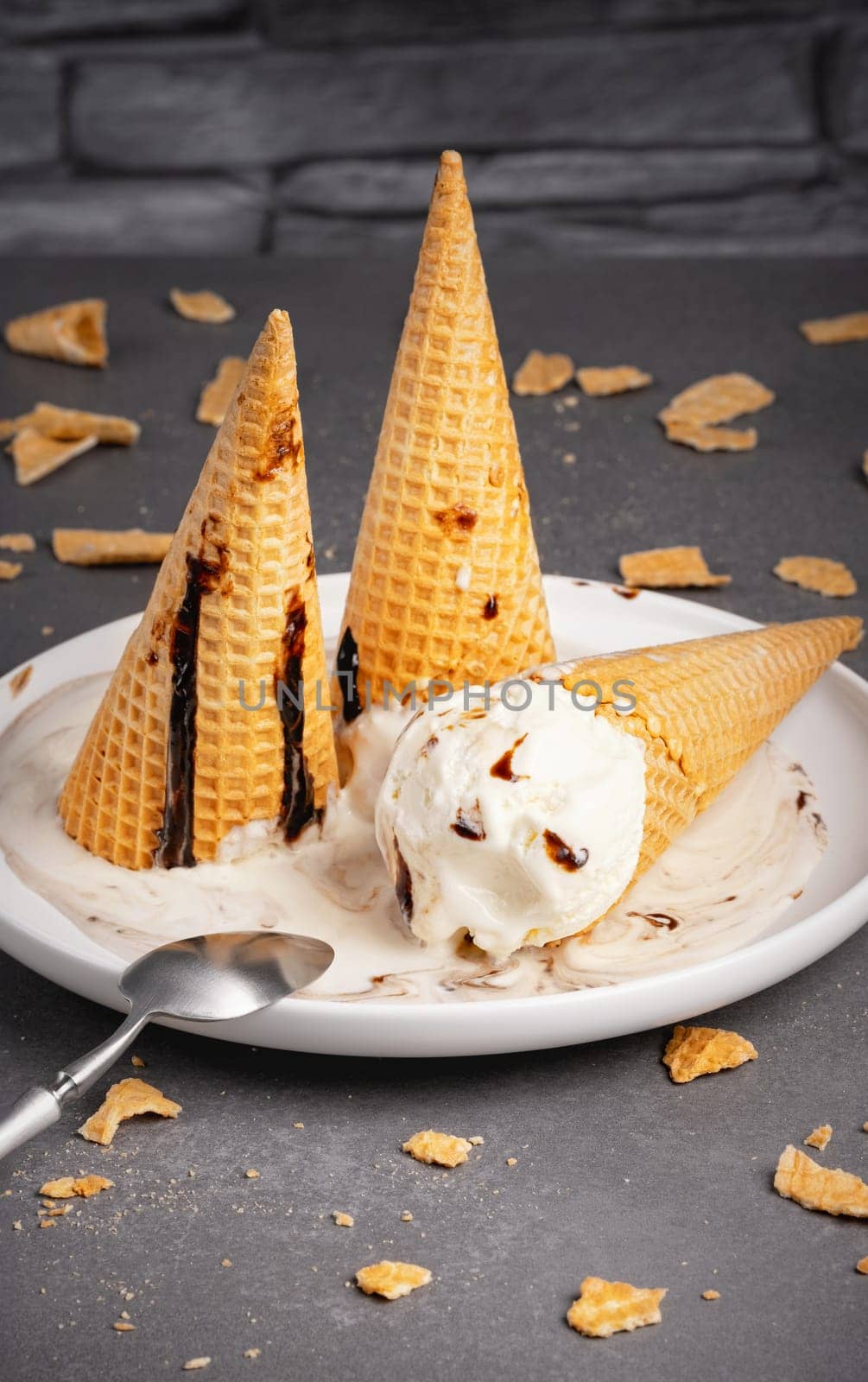 Vanilla ice cream cone pouring.