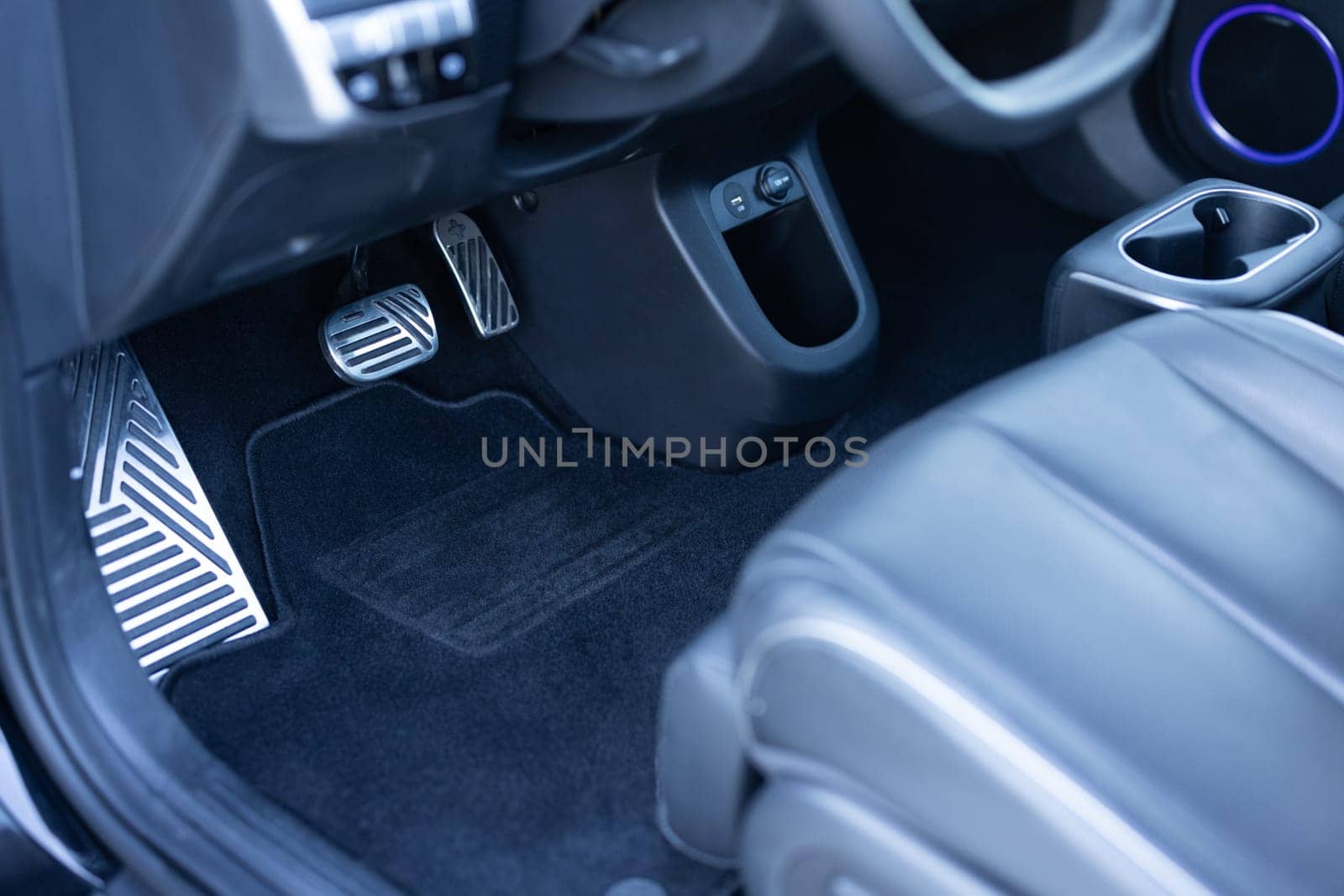 Electric car interior details. Vehicle Gas Brake Pedal, car pedals. Detailing of modern electric car, Brake and accelerator pedal of electric car interior. Brakes and accelerator pedals EV vehicle. by uflypro