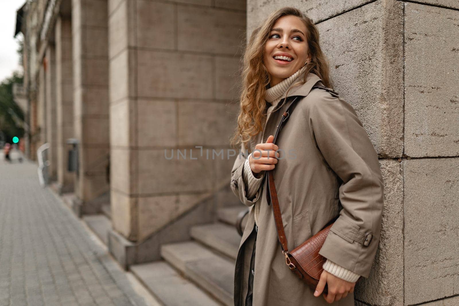Autumn portrait of young fashionable woman wearing trendy coat in the street by Fabrikasimf