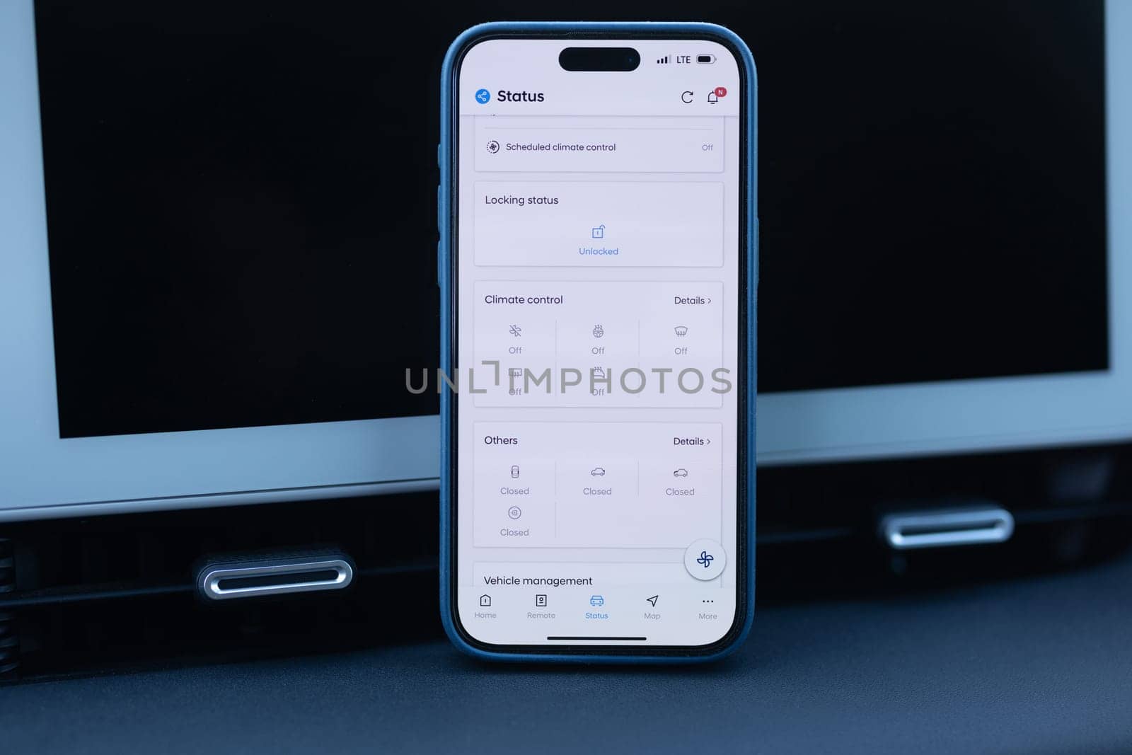 Using EV application on his phone to check charging status. Fictional application. Smart EV mobile application while EV car. Electric car app on smart phone by uflypro