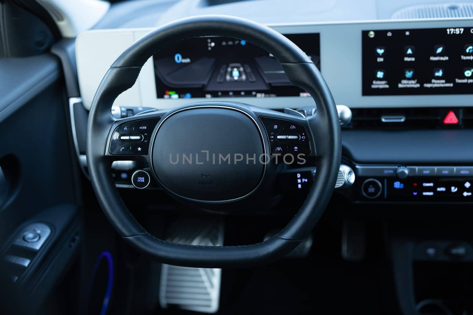 Steering wheel of electric vehicle, interior, cockpit, electric buttons. Autonomous car. Driverless car. Self-driving vehicle. Empty cockpit electric vehicle, Head Up Display and digital speedometer by uflypro