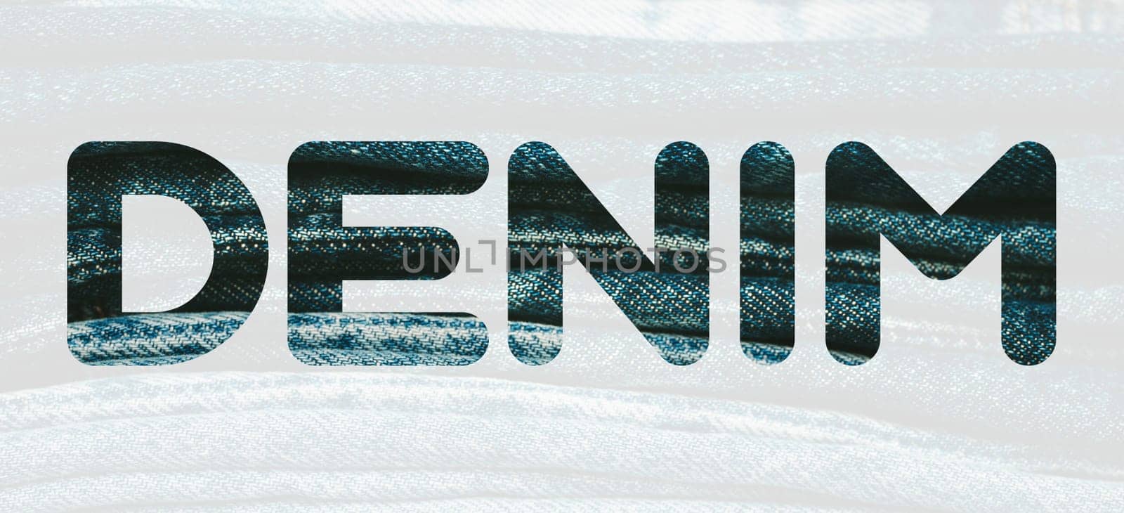 Word DENIM from denim blue pattern of folded jeans background. Fashion, stock and magazine concept. Denim font. by DariaKulkova