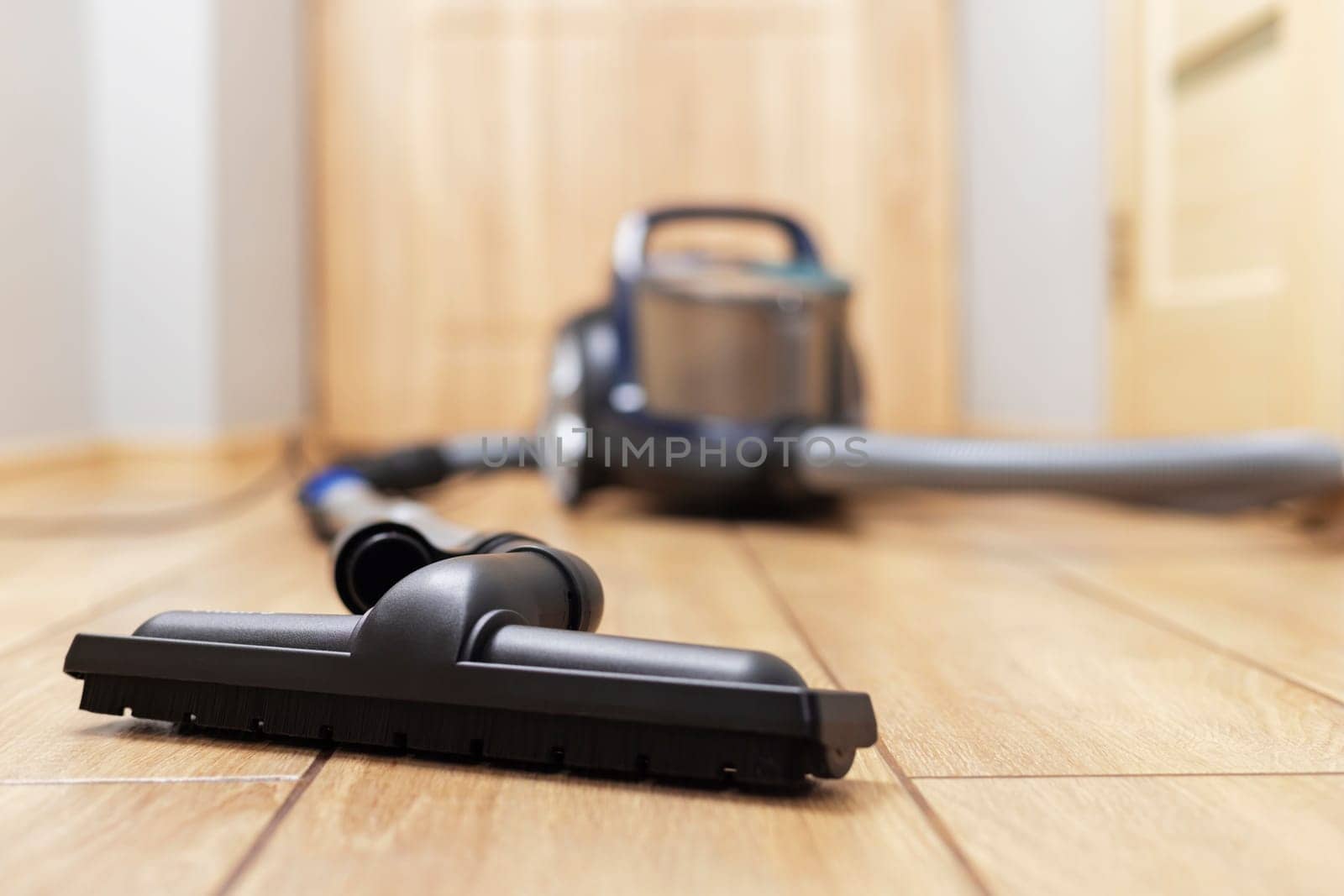 Vacuum Cleaner on Wooden Floor by andreyz