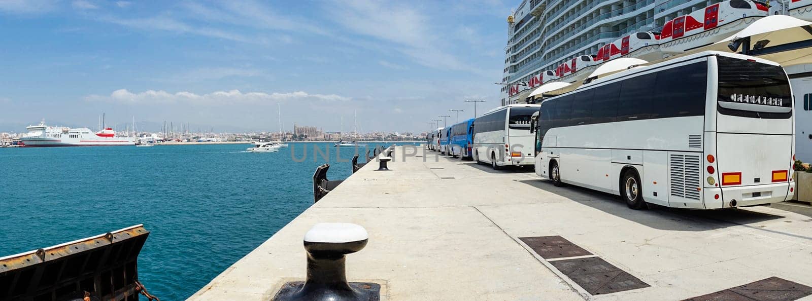 Bustling Port Scene with Tour Buses Lined Up Alongside a Cruise Ship by Juanjo39