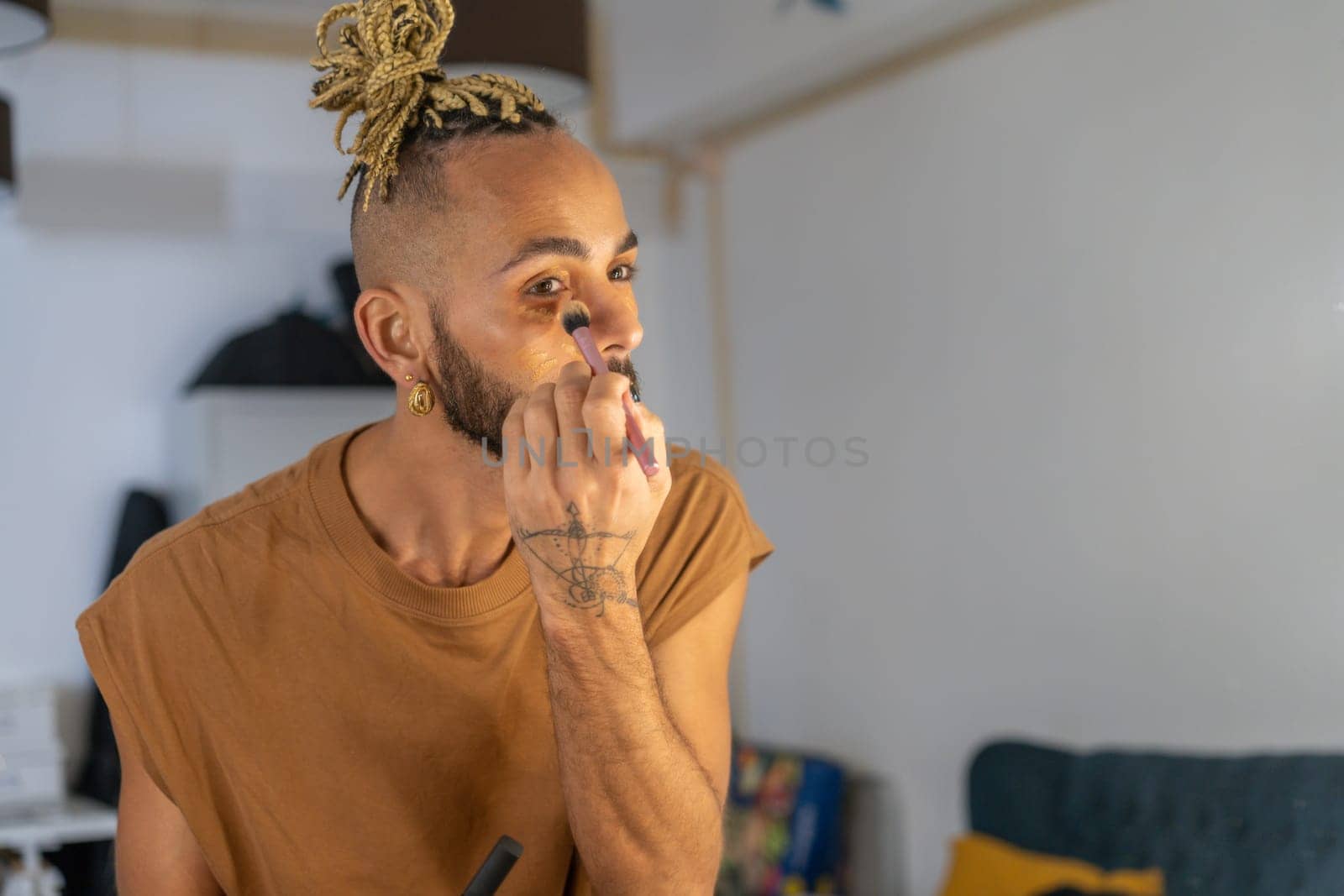 Black brazilian gay applying make up eyeshadow looking mirror view from behind. Non binary guy. LGBT People lifestyle fashion lgbtq concept