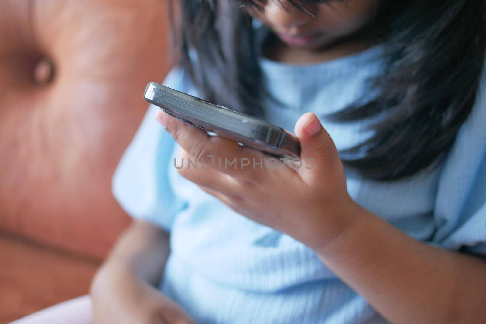 Child girl watching cartoon on smart phone ,