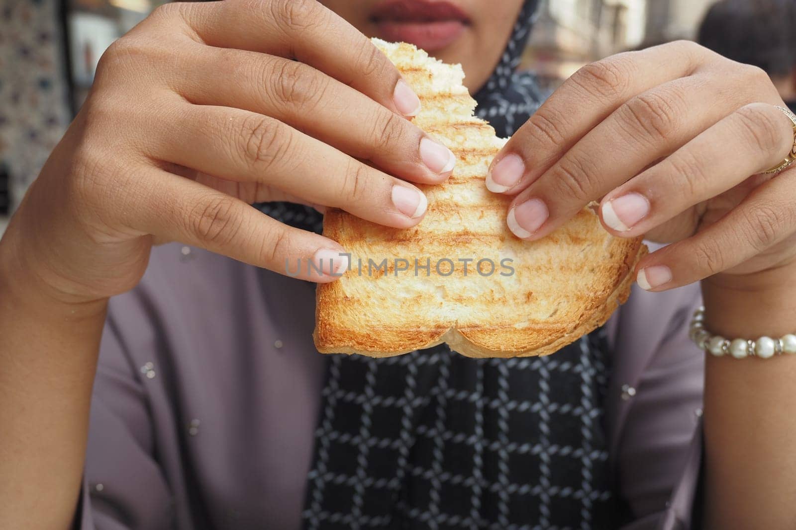 woman hand pick Sandwich with ham, cheese, tomatoes,,.