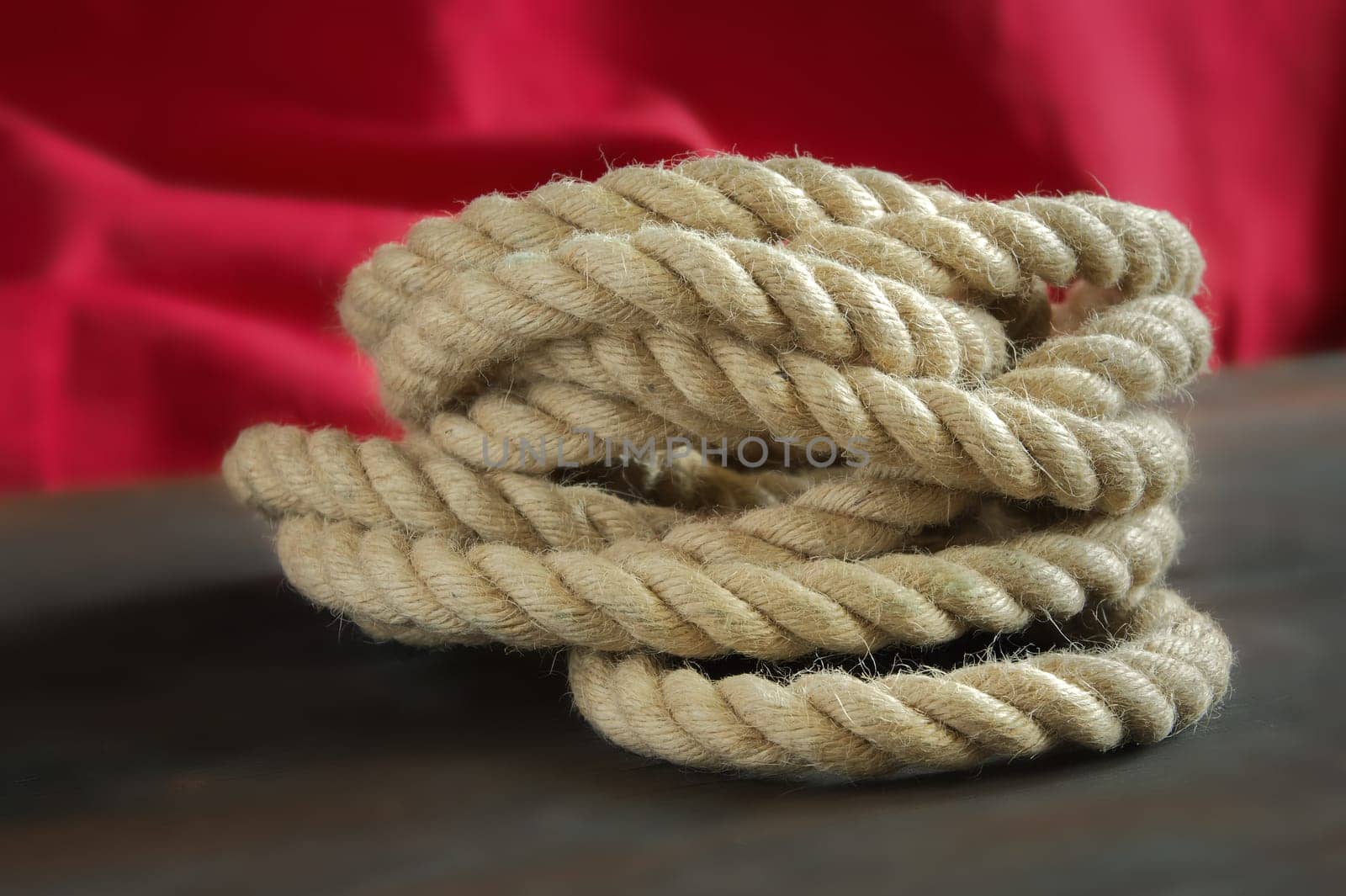 Coil of rope made of hemp or jute, braided texture and consistent thickness with a deep beige color