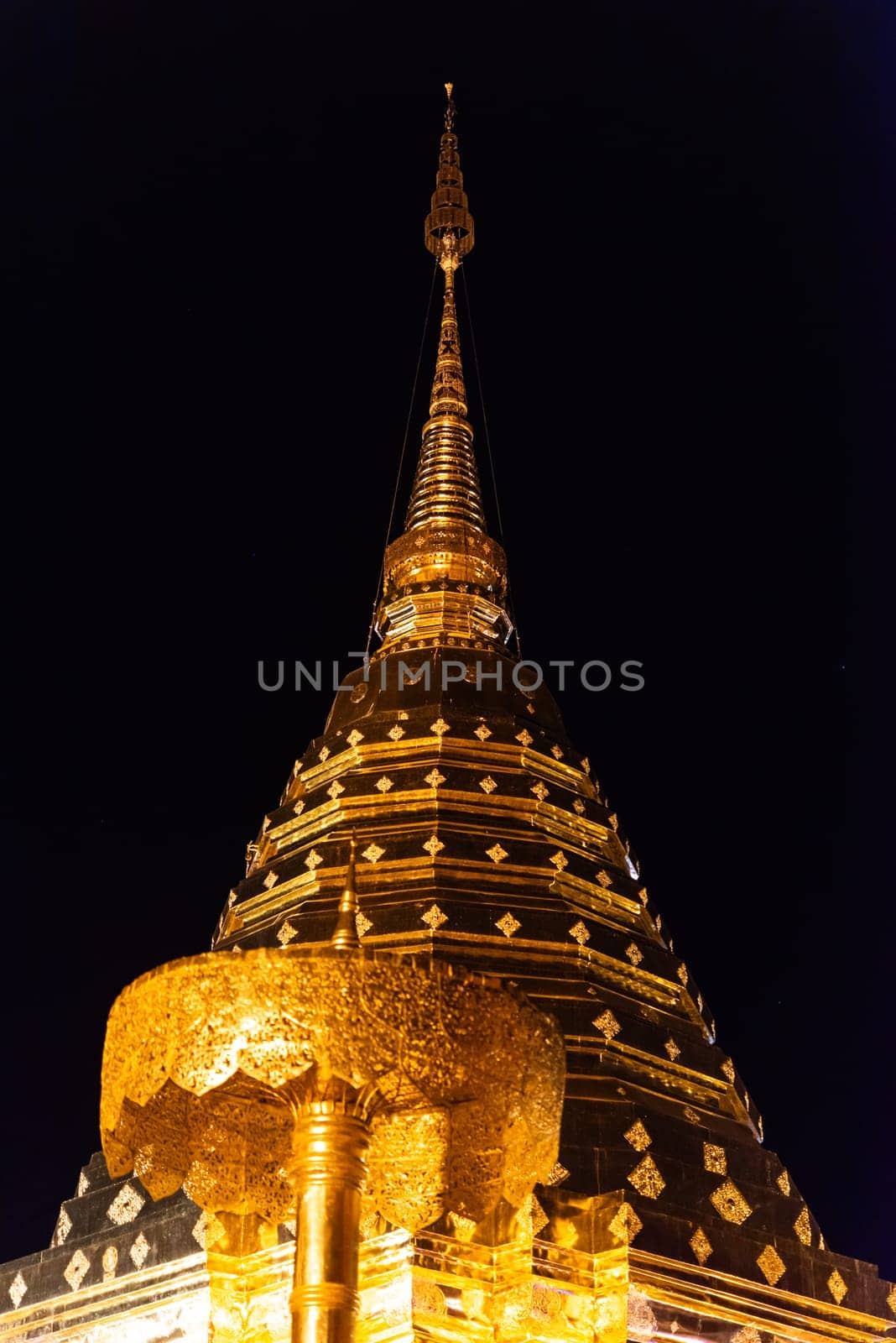 Chiang Mai, Thailand - January 8, 2022 : Wat Phra That Doi Suthep at night time is buddhist temple (wat) in Chiang Mai province. Within the site are pagodas, statues, bells, a museum, and shrines.