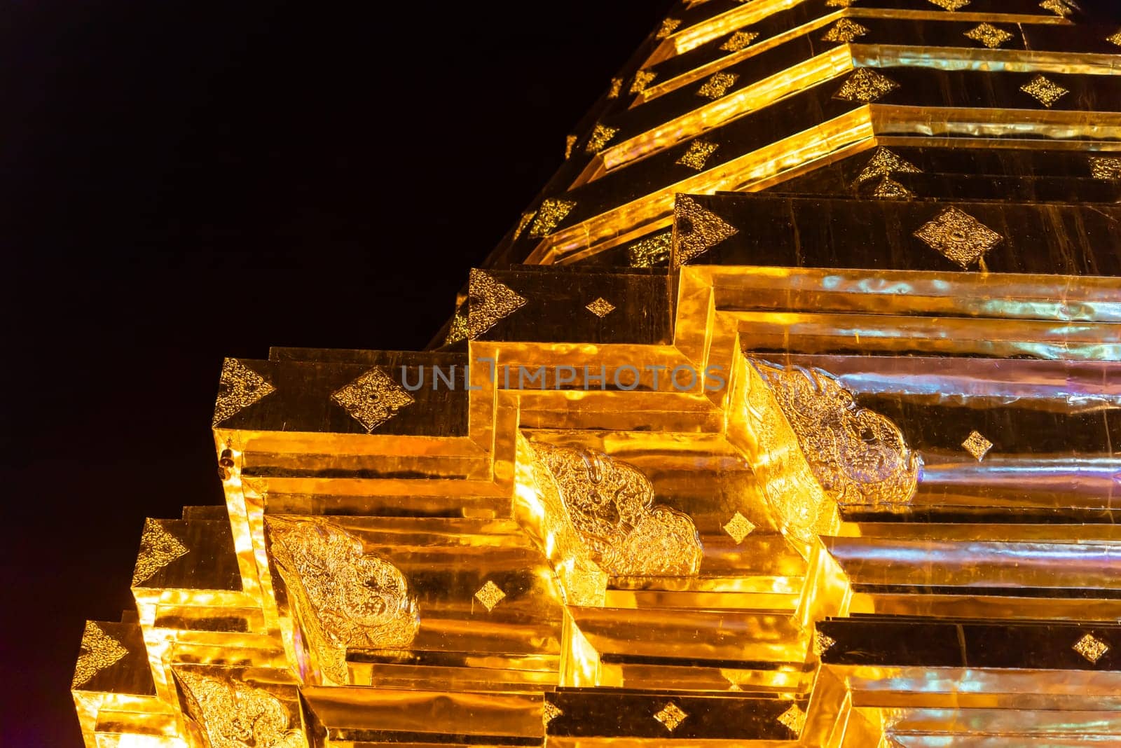 Chiang Mai, Thailand - January 8, 2022 : Wat Phra That Doi Suthep at night time is buddhist temple (wat) in Chiang Mai province. Within the site are pagodas, statues, bells, a museum, and shrines.