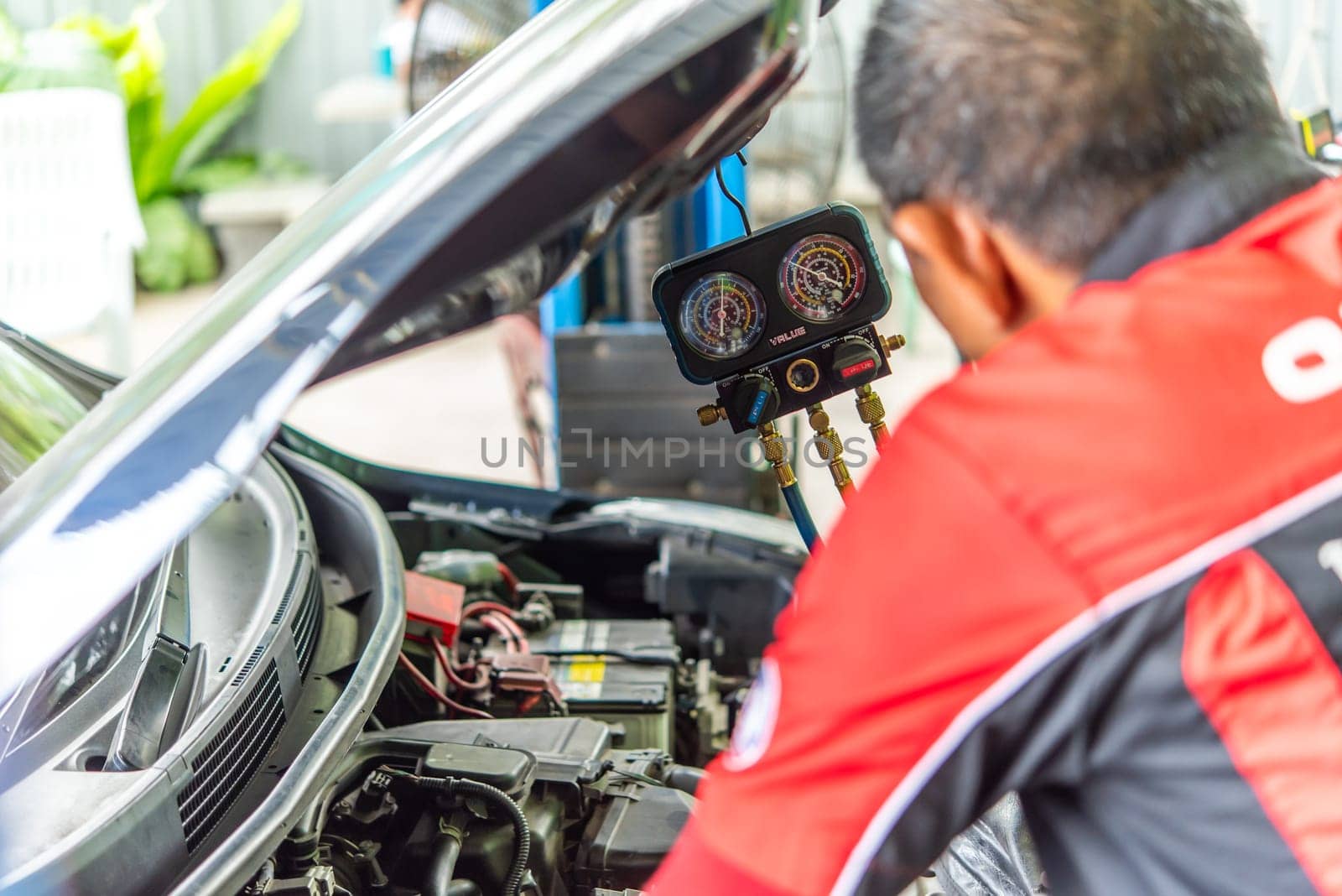 Car refilling air condition at car garage by PongMoji