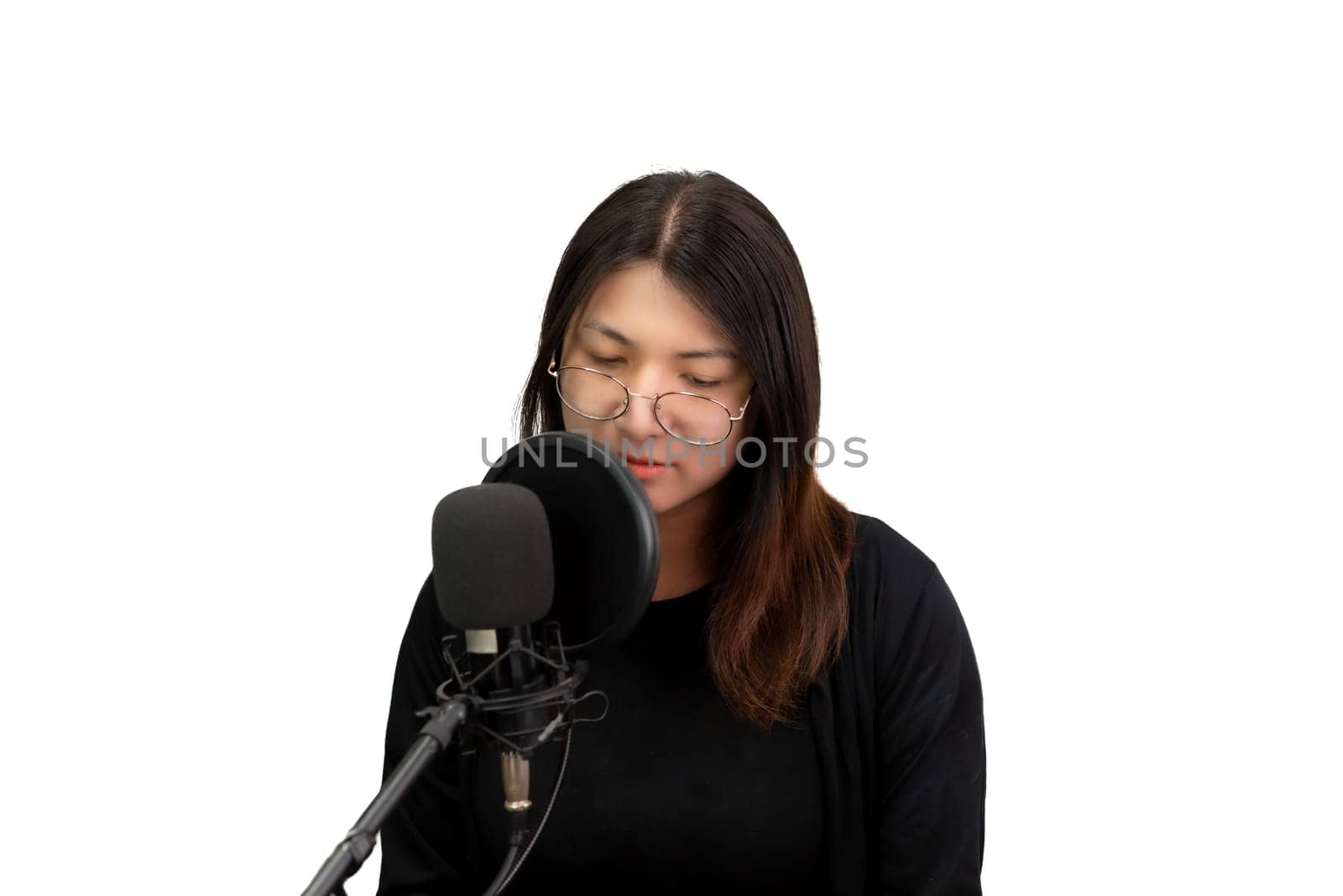 Beautiful asian woman (LGBTQ) is a singer. She enjoying sing a song or karaoke in music studio with microphone condenser and headphones for fun or voice creative