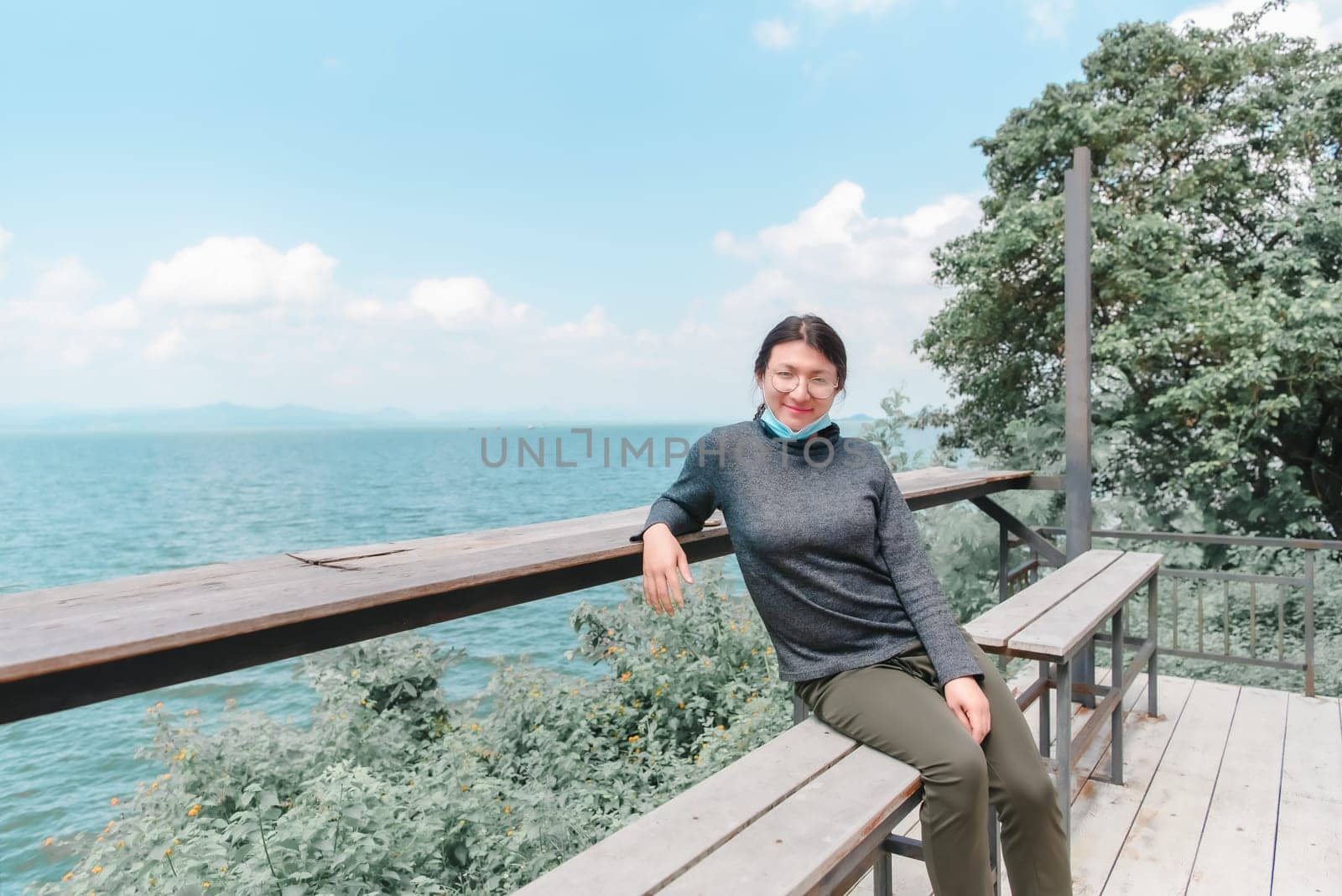 Woman (LGBTQ) posing at sea viewpoint with happy by NongEngEng