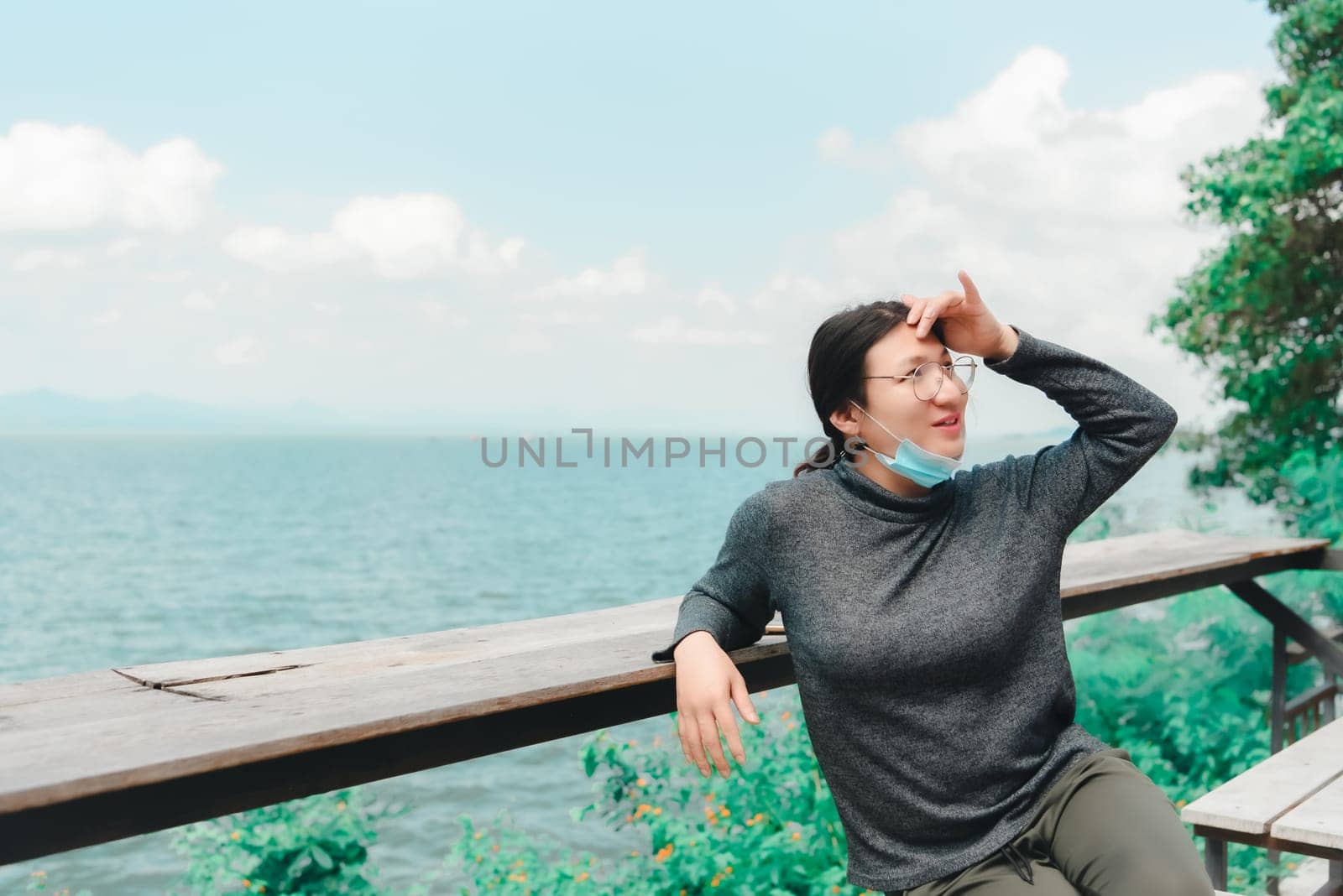 Woman (LGBTQ) posing at sea viewpoint with happy by NongEngEng