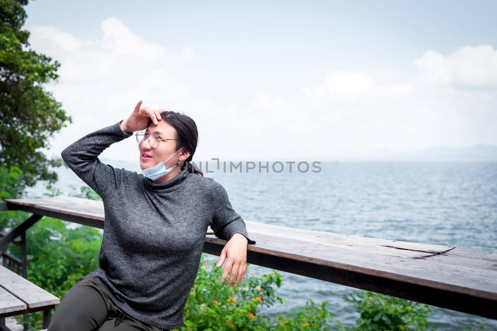 Beautiful asian woman (LGBTQ) natural makeup wear fashion relax clothes posing at sea viewpoint with happy and fun emotion in concept travel, vacation, leisure in life