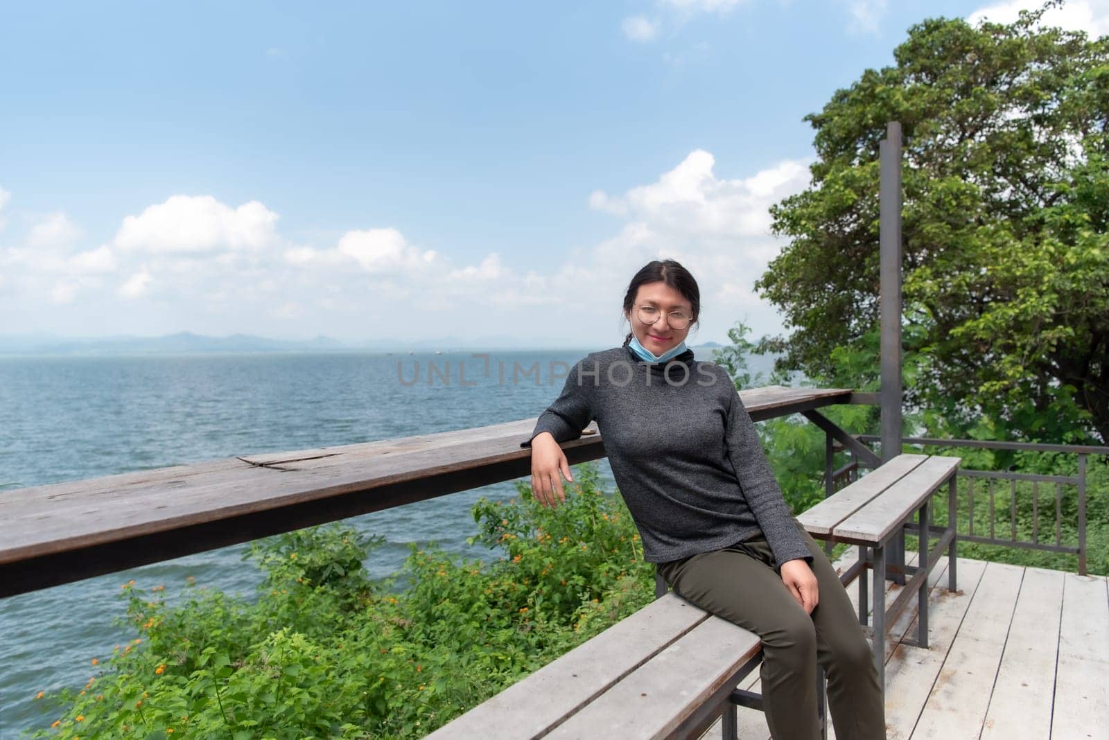 Woman (LGBTQ) posing at sea viewpoint with happy by NongEngEng