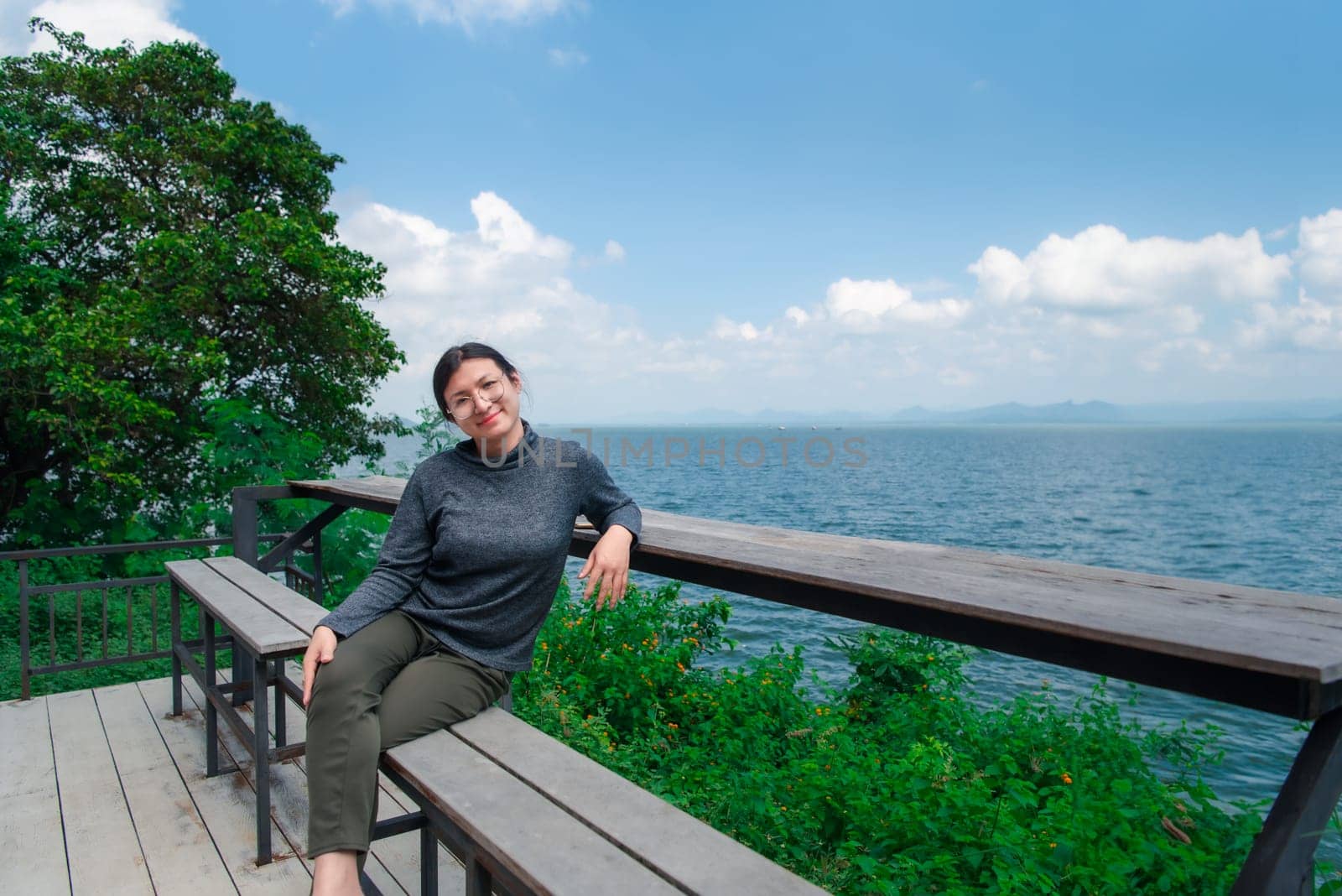 Woman (LGBTQ) posing at sea viewpoint with happy by NongEngEng