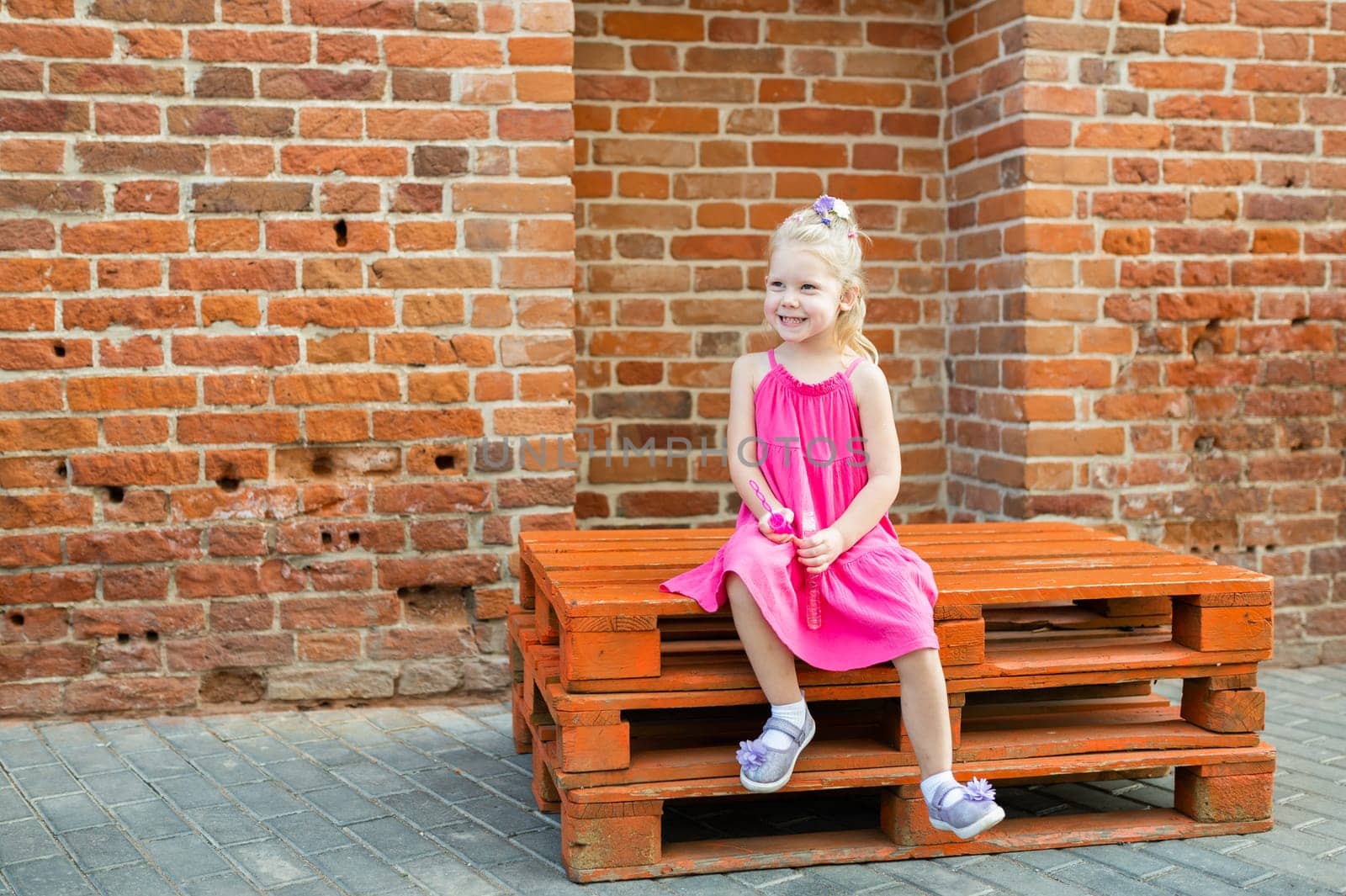 Child have fun with cochlear implant hearing aid in summer city. Inclusion and modern technologies for treating hearing loss. Copy space by Satura86