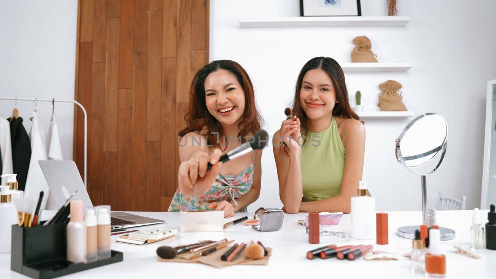 Two influencer partner shoot live streaming vlog video review makeup social media or blog. Happy young girl with vivancy cosmetics studio lighting for marketing recording session broadcasting online.