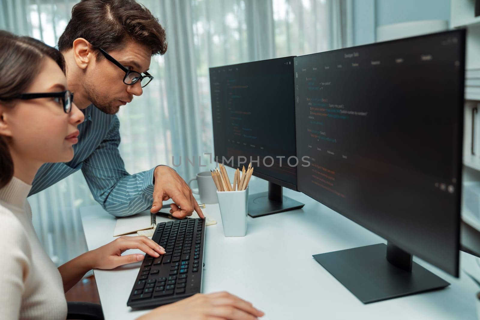 Team skilled developers program thinking newest coding creative website planning software project on two pc screen, comparing with typing full stack data analyzing prompt design at office. Postulate.