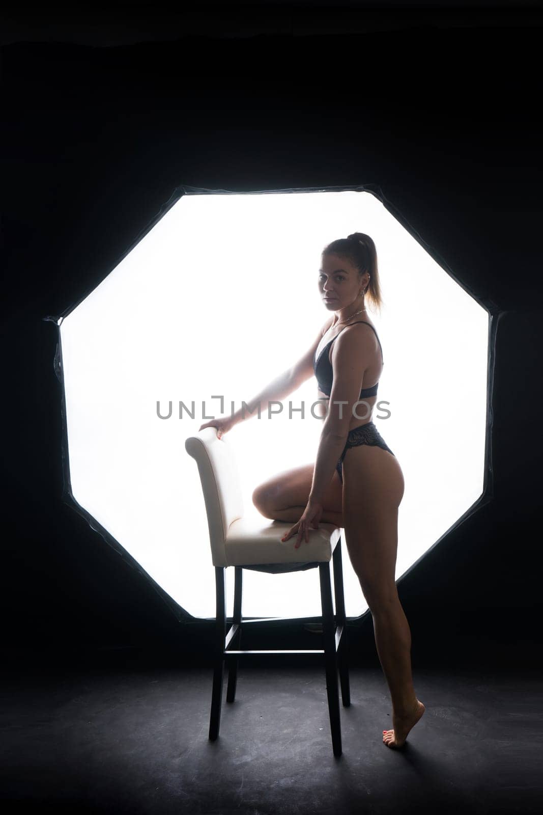 Silhouette of a beautiful young woman wearing underwear in backlight by Zelenin