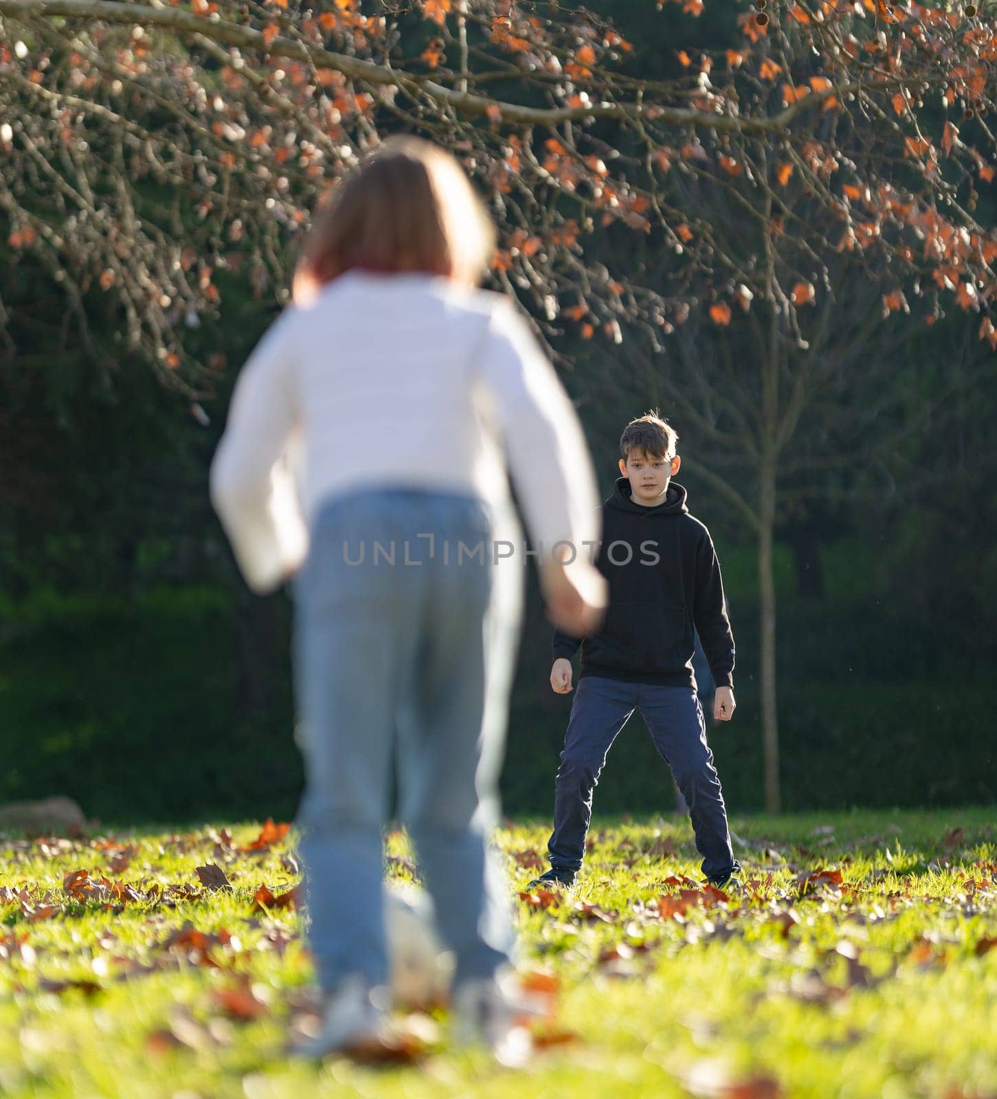 A boy and a girl are playing in a park by Studia72