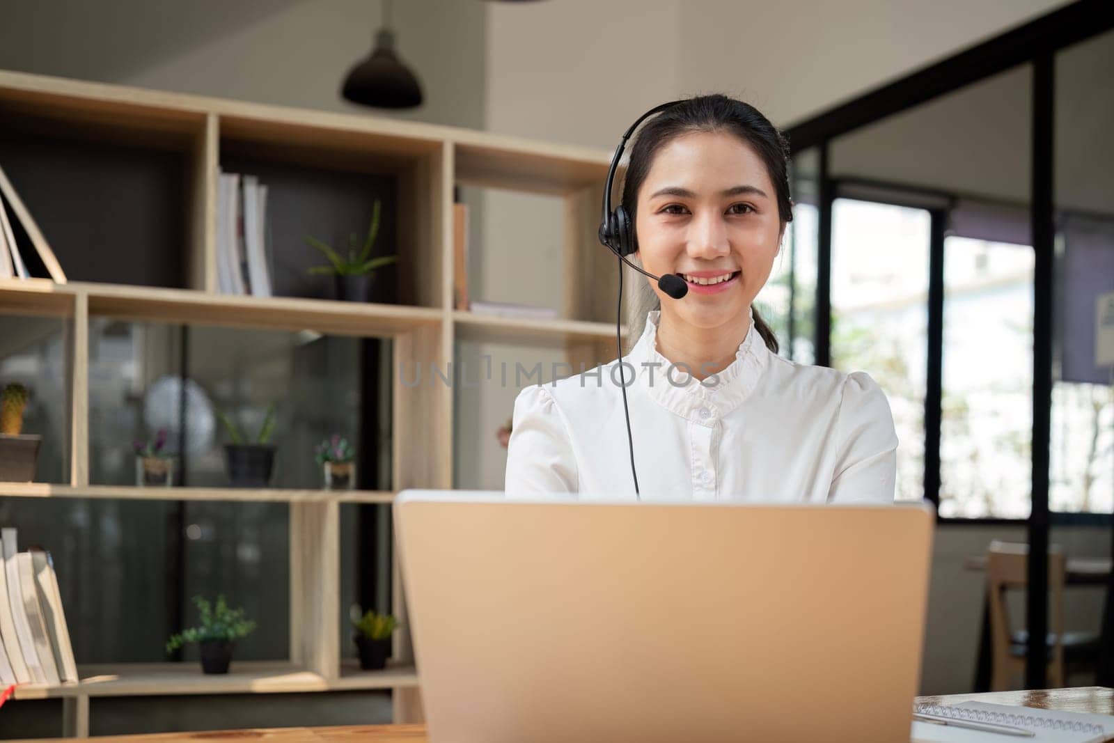 Call center friendly woman asian in office for customer service, technical support and advice, contact and communication with employee operator in help desk agency.