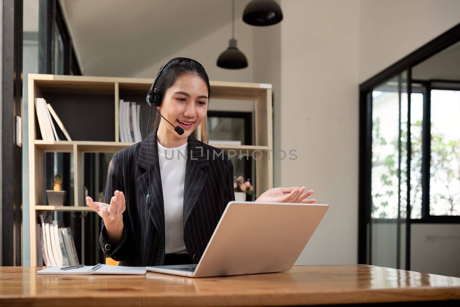 Call center friendly woman asian in office for customer service, technical support and advice, contact and communication with employee operator in help desk agency by nateemee