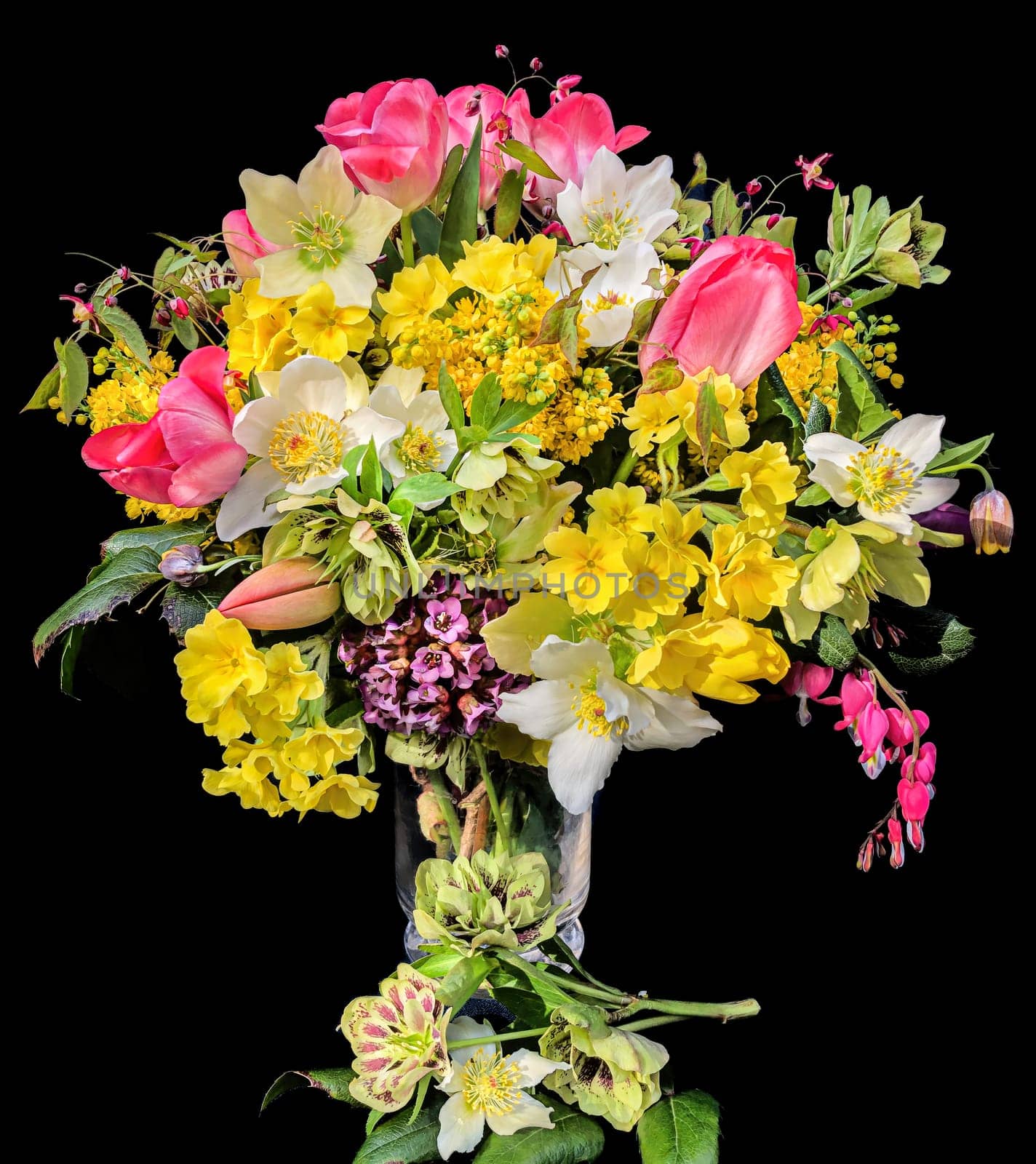 Romantic bouquet of the first garden flowers isolated on black background. The art of flower arranging