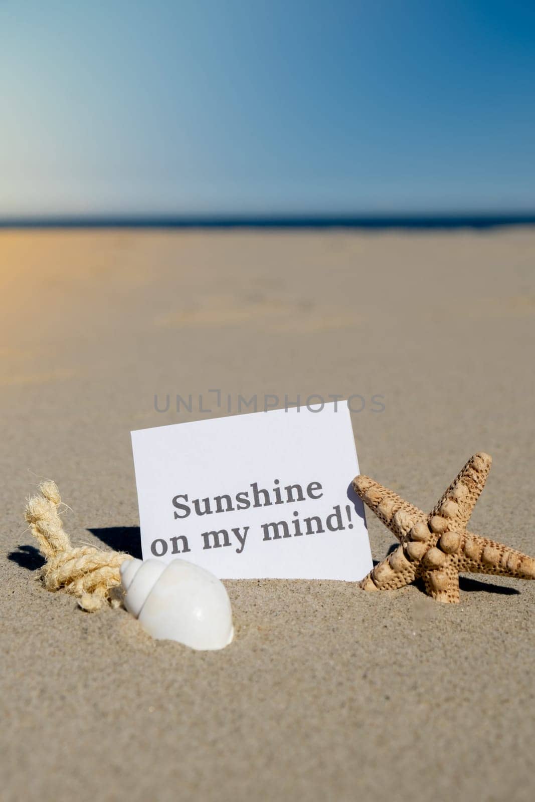 SUNSHINE ON MY MIND text on paper greeting card on background of starfish seashell summer vacation decor. Sandy beach sun coast. Holiday concept postcard. Getting away Travel Business concept