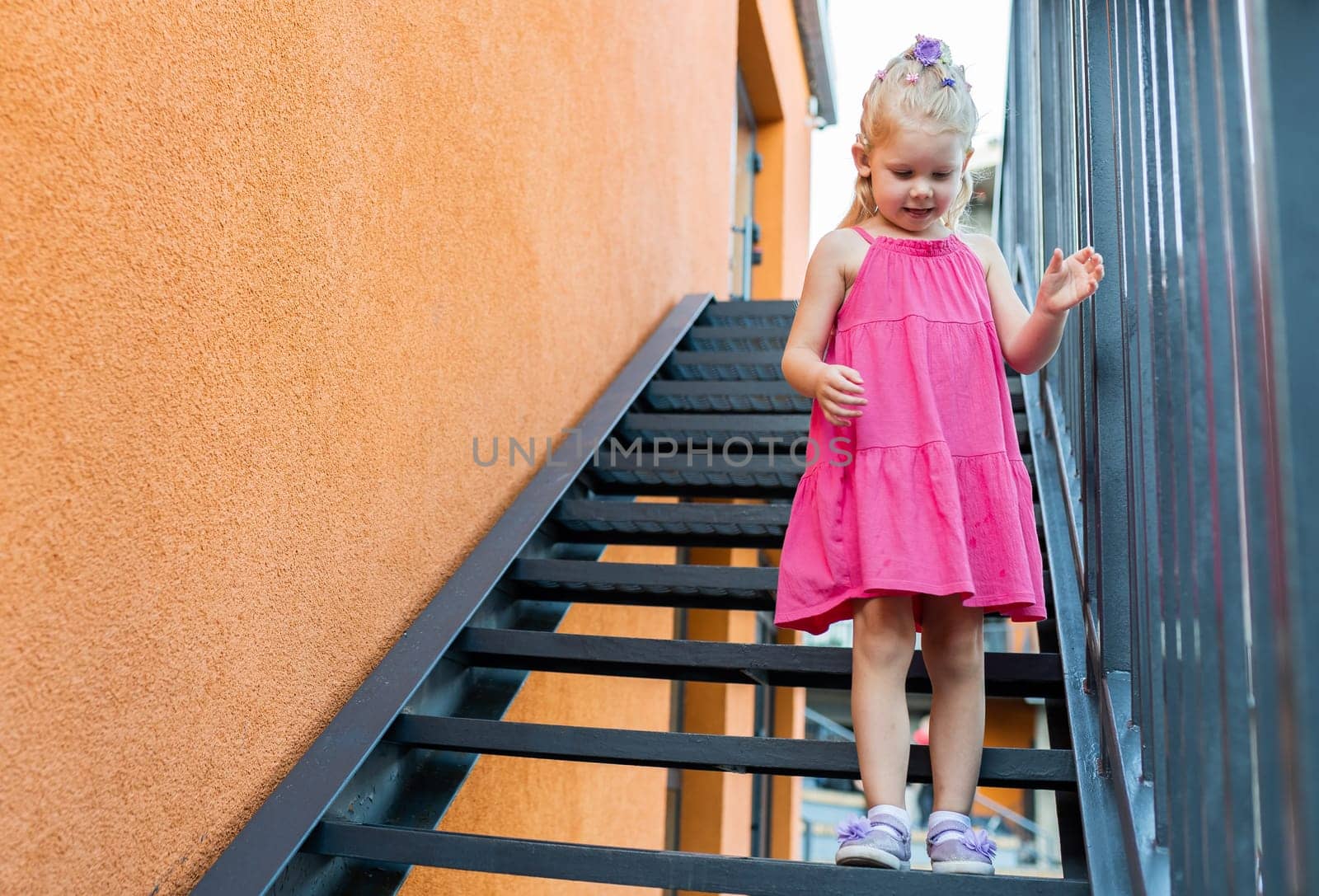 Child walks with cochlear implant system. Installation cochlear implant on child girl ear for restores hearing. Kid hears after hear return to normal. Diversity inclusion concept. Copy space by Satura86