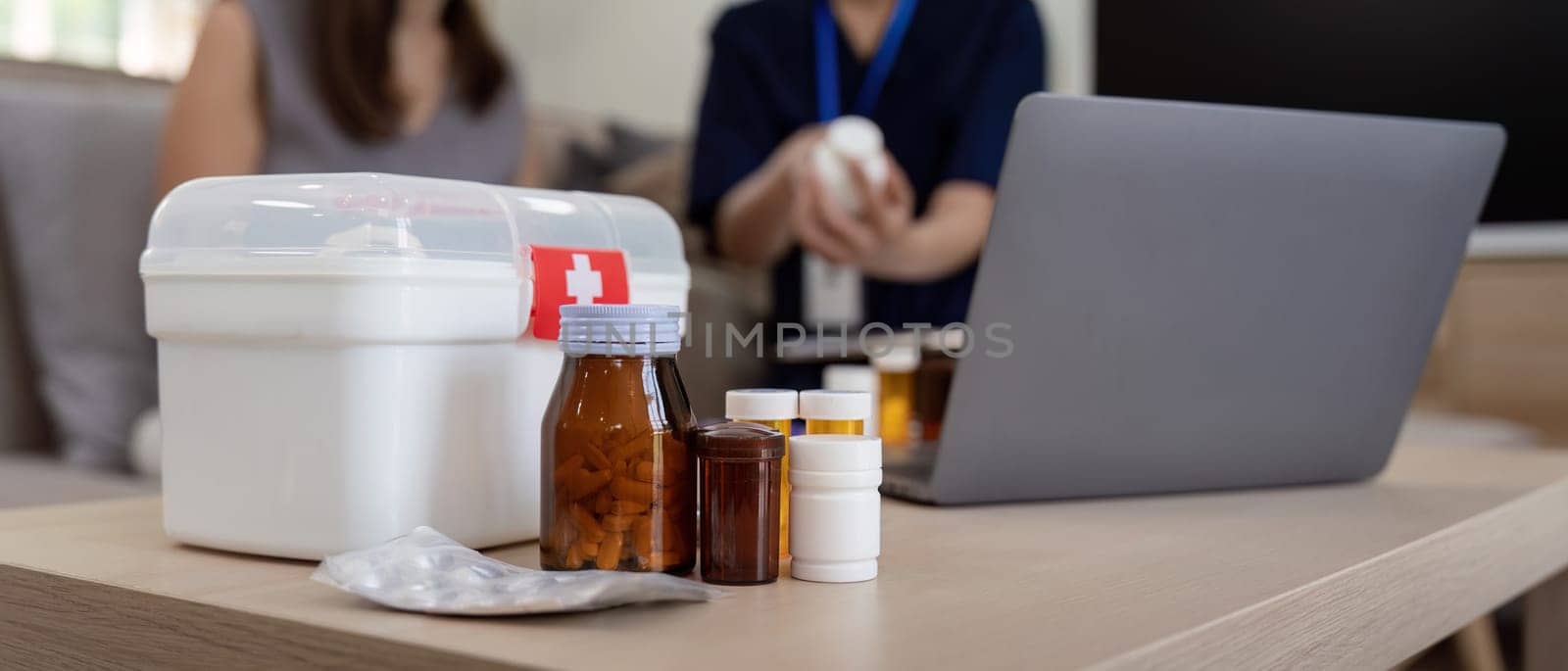 Caregiver woman hold medicine pill bottle, explain prescription to elderly old woman in living room in house by nateemee